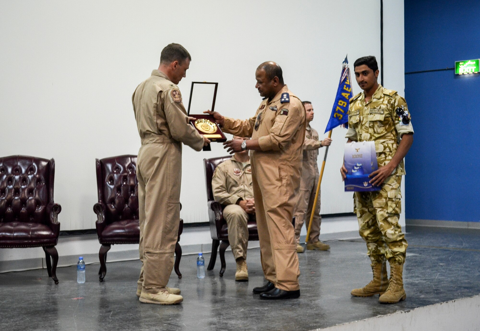 Col. John Lamontagne is presented a gift by the Al Udeid Air Base Qatari commander, Brig. Gen. Fahad Al-Uraik, during a change of command ceremony April 27, 2014. Lamontagne is being replaced as the 379th Expeditionary Operations Group commander by Col. James Dittus, who is coming from Scott Air Force Base, Ill., as the 618th Air and Space Operations Center director of staff. Lamontagne will be heading to the 437th Airlift Wing at Joint Base Charleston, as the commander. (U.S. Air Force photo/Senior Airman Jared Trimarchi)