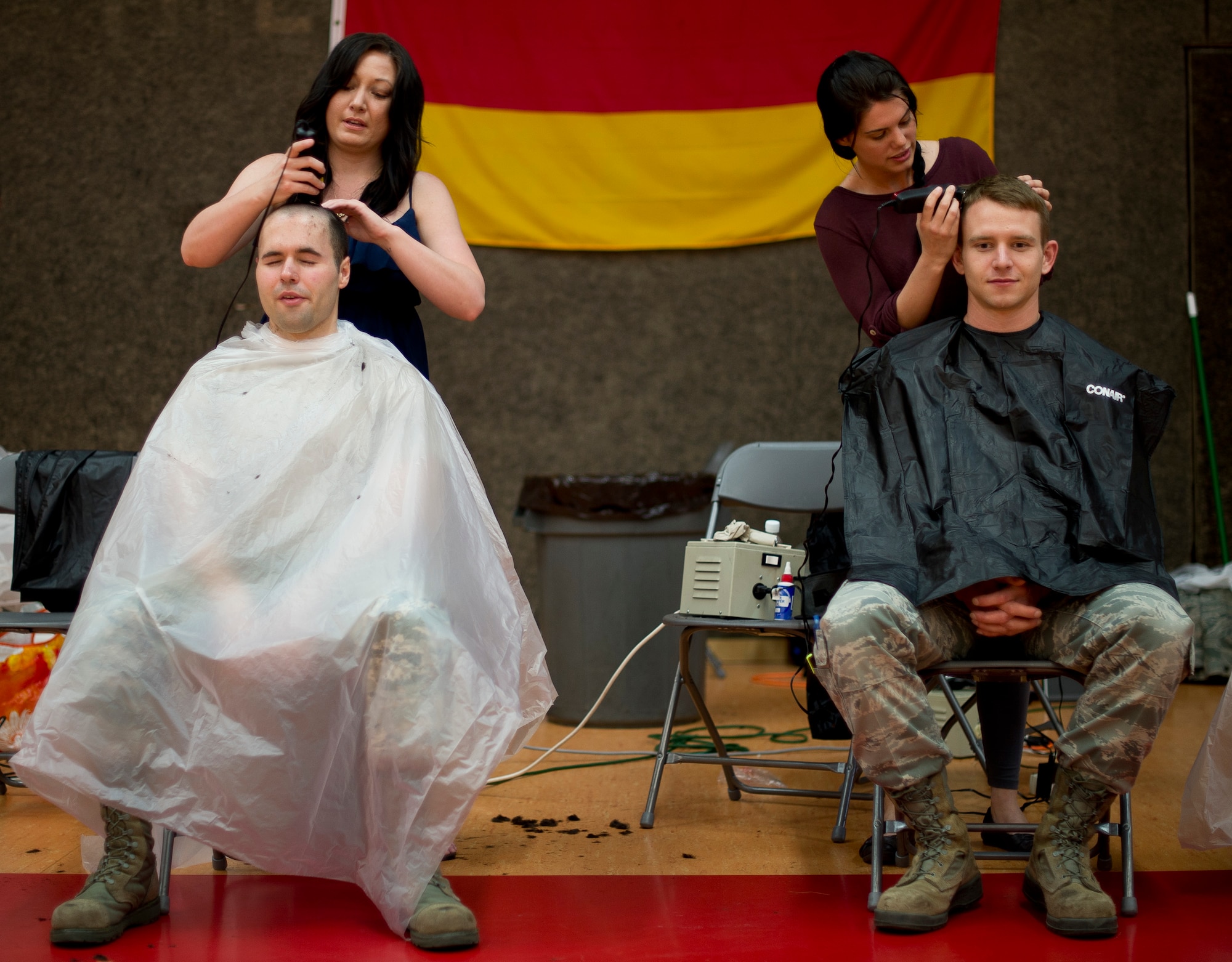 Volunteers for “Go Bald for Brayden” give haircuts to participants April 25, 2014, at Spangdahlem Air Base, Germany, during an event to show support for Brayden Mitchell, 5, recently diagnosed with a form of kidney cancer. Following Brayden’s diagnosis, military members from around the globe have showed their support by shaving their heads. (U.S. Air Force photo by Staff Sgt. Chad Warren/Released)