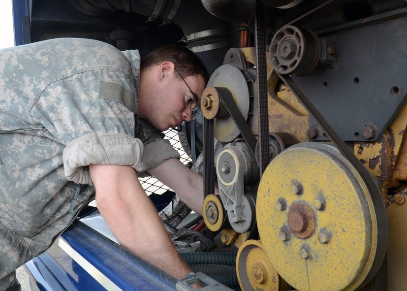 U.S. Air Force Senior Airman Efrain Valentin, 100th Logistics Readiness Squadron vehicle maintenance journeyman from Hollywood, Fla., inspects a vehicle engine April 30, 2014, on RAF Mildenhall, England. Valentin is one of the 100th LRS members working behind the scenes to keep vehicles in service and on the road. (U.S. Air Force photo by Airman 1st Class Kyla Gifford/Released)