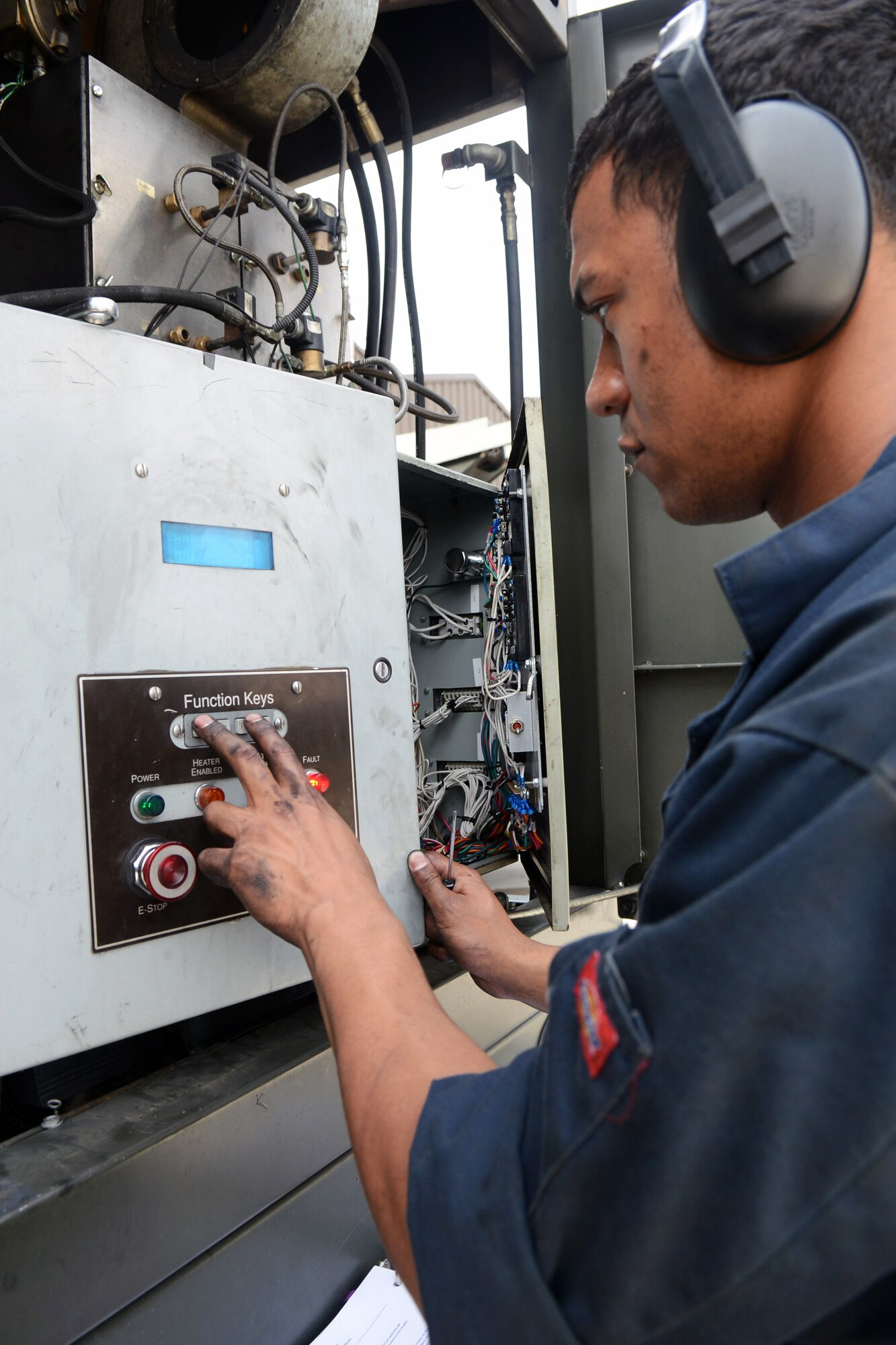 U.S. Air Force Staff Sgt. Jordan McCarther, 100th Logistics Readiness Squadron NCO in charge of special-purpose vehicle maintenance from Rapid City, S.D., adjusts blower-motor speed on a de-icer truck April 30, 2014, on RAF Mildenhall, England. The trucks must be ready for use by winter so they can keep the roads and runway safe for travel. (U.S. Air Force photo by Airman 1st Class Kyla Gifford/Released)