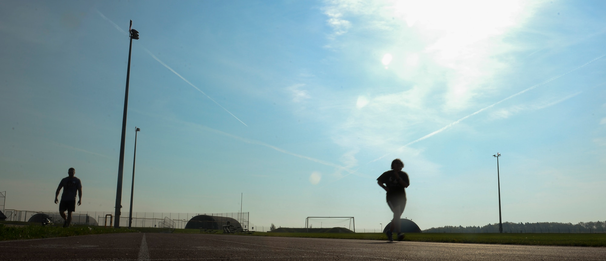 U.S. Air Force Tech. Sgt. Mark Salzaman, a 372nd Training Squadron Detachment 17 F-16 Fighting Falcon avionics instructor, watches Staff Sgt. India Smith, a 372nd TRS Det. 17 NCO in charge of knowledge operations, complete a half-mile run during a half “Murph” workout April 25, 2014, at Spangdahlem Air Base, Germany. Smith said she wanted to complete a full “Murph” workout as a means to score in the “excellent” category on her next physical fitness test. (U.S. Air Force photo by Senior Airman Rusty Frank/Released)