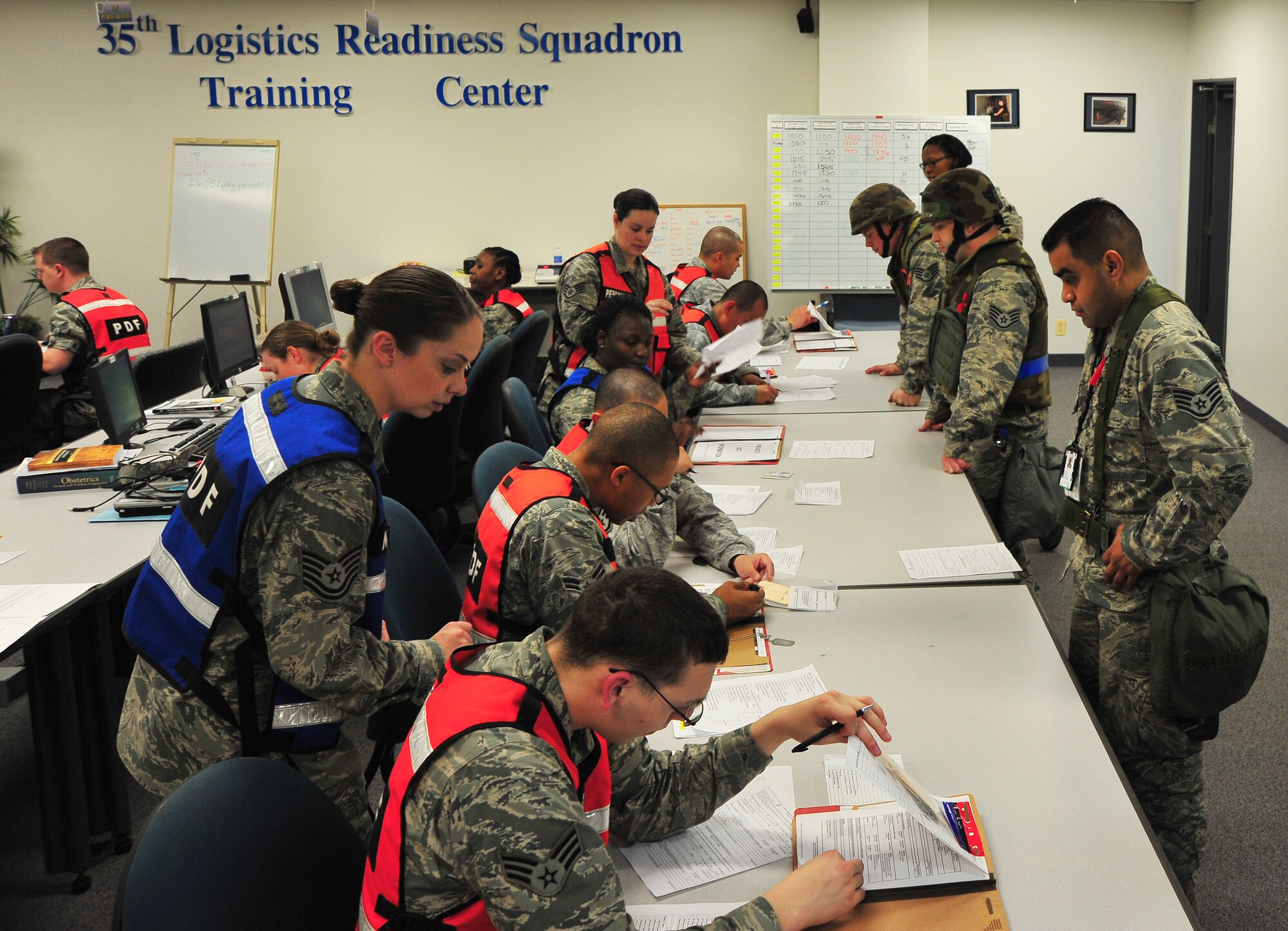 U.S. Air Force Personnel check mobility paperwork of “deploying” Airmen in a personnel deployment function line during Phase I of an Operational Readiness Exercise at Misawa Air Base, Japan, May 1, 2014. As part of this exercise, a PDF line is set up to ensure a streamlined process for verifying paperwork and training necessary for deployment. (U.S. Air Force photo/Senior Airman Jose L. Hernandez-Domitilo)