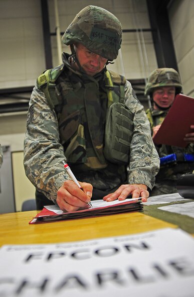 U.S. Air Force Tech. Sgt. Robert Schmidt, 35th Maintenance Squadron aerospace ground equipment craftsman, fills out an individual protective equipment clothing size sheet as part of Phase I of an Operational Readiness Exercise at Misawa Air Base, Japan, May 1, 2014. During this exercise, the 35th Logistics Readiness Squadron individual protective equipment unit is evaluated on their ability to supply Airmen with necessary deployment equipment in a timely manner. (U.S. Air Force photo/Senior Airman Jose L. Hernandez-Domitilo)