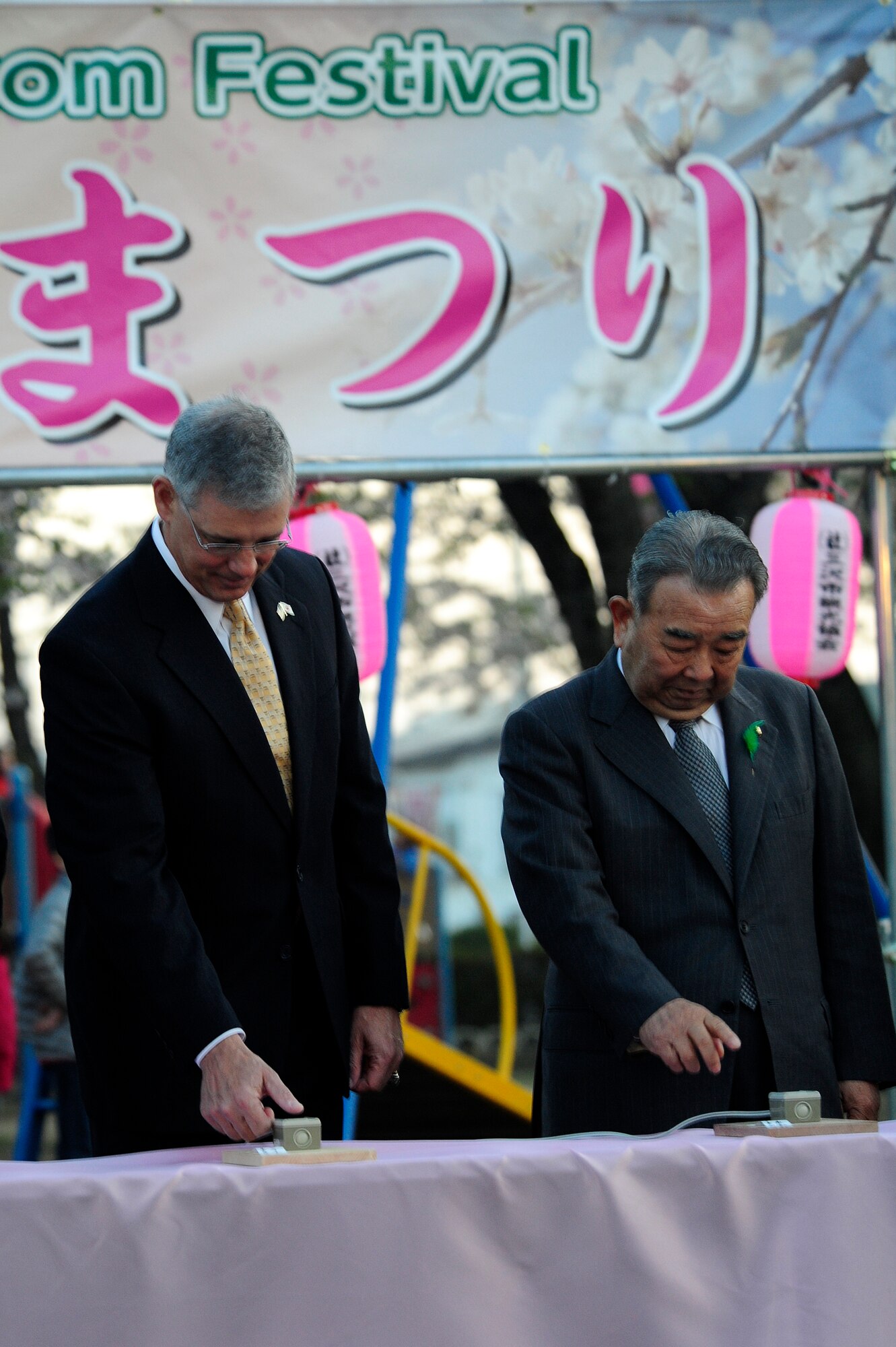 U.S. Air Force Lt. Gen. Sam Angelella, U.S. Forces, Japan and 5th Air Force commander, joins Kazumasa Taneichi, Misawa City mayor, at the Misawa cherry blossom festival to light the lanterns surrounding the park in Misawa City, Japan, April 29, 2014. This event demonstrates the continued support between U.S. and Japanese forces and the willingness to maintain a strong bilateral relationship. (U.S. Air Force/Tech. Sgt. April Quintanilla)