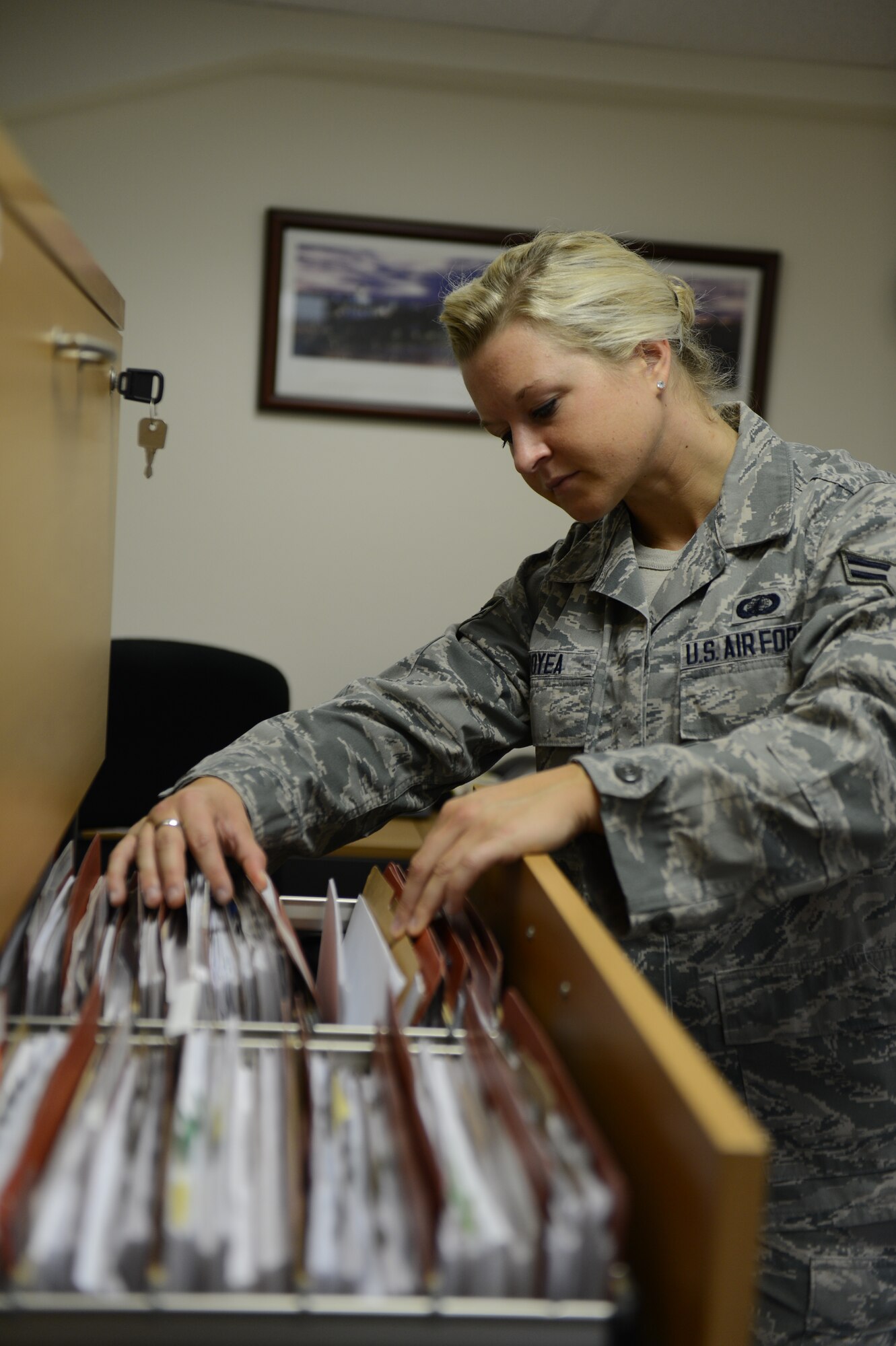 U.S. Air Force Airman 1st Class Tessa Boyea, 52nd Contracting Squadron contracting officer from Saratoga Springs, N.Y., sifts through a cabinet full of contracts on Spangdahlem Air Base, Germany, April 24, 2014. Last year, the 52nd CONS overlooked 739 contract actions adding up to about $15.9 million. (U.S. Air Force photo by Senior Airman Gustavo Castillo/Released)