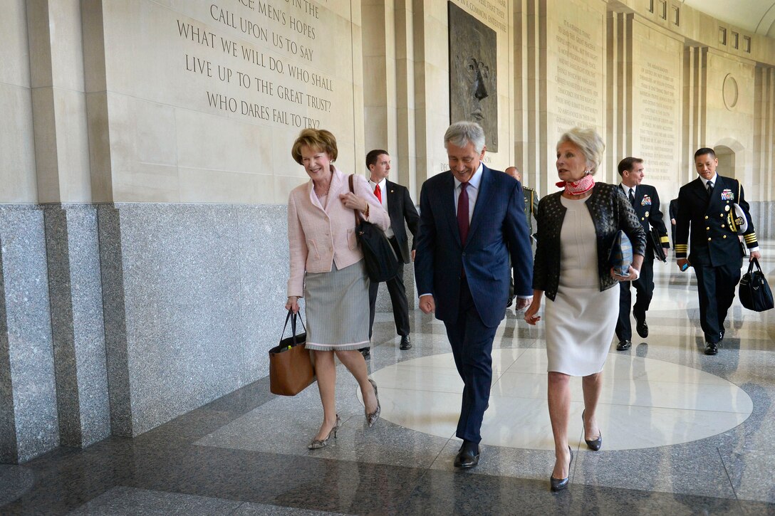 Jane Harman, director, president and CEO of the Wilson Center, right, escorts Defense Secretary Chuck Hagel, past a facade of Woodrow Wilson before delivering remarks at the Wilson Center in the Ronald Reagan Building and International Trade Center in Washington, D.C., May 2, 2014.