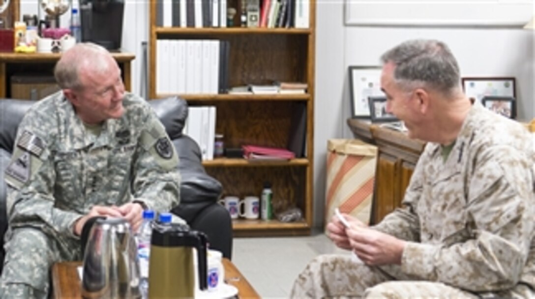 U.S. Army Gen. Martin E. Dempsey, chairman of the Joint Chiefs of Staff, left, talks with U.S. Marine Corps Gen. Joseph F. Dunford Jr., the commander of the International Security Assistance Force, during a visit to Bagram Airfield, Afghanistan, May 2, 2014. Dempsey is in Afghanistan to visit troops and commanders. 