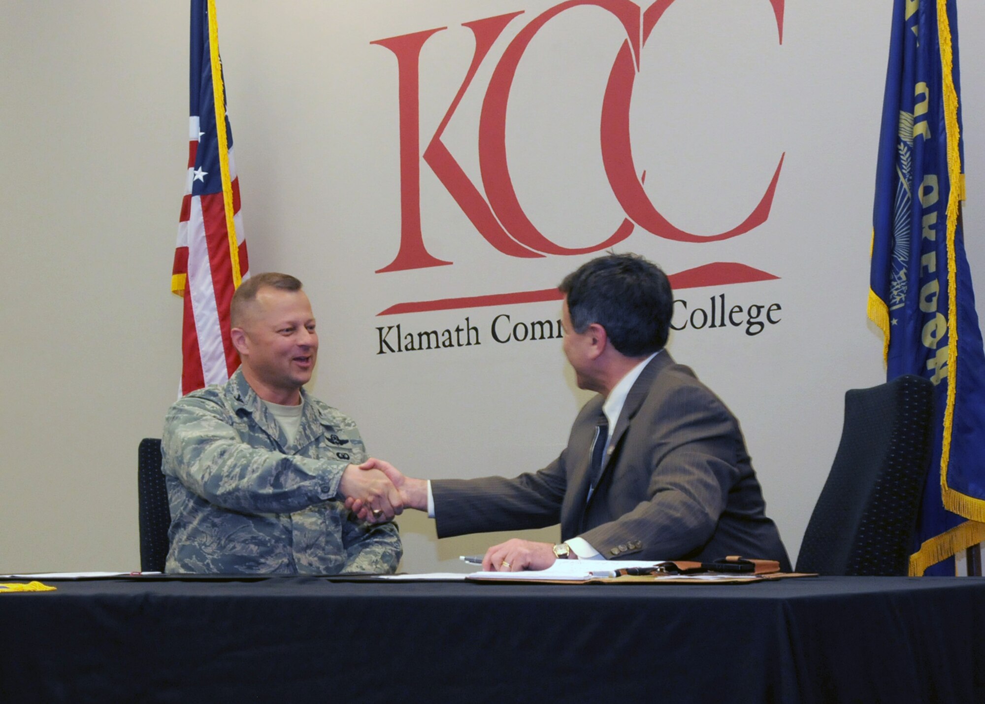 Oregon Air National Guard Col. Gregor Leist, 173rd Fighter Wing Vice Wing Commander, and Dr. Roberto Gutierrez, Klamath Community College President, sign a memorandum of understanding outlining their continuing partnership at KCC in Klamath Falls, Ore., April 16, 2014. The agreement between Kingsley Field and KCC will help members complete their Community College of the Air Force Degrees which will soon be mandatory for promotions. (U.S. Air National Guard photo by Senior Airman Penny Snoozy/Released)