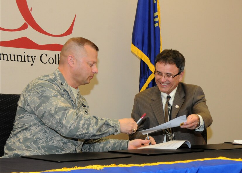 Oregon Air National Guard Col. Gregor Leist, 173rd Fighter Wing Vice Wing Commander, and Dr. Roberto Gutierrez, Klamath Community College President, sign a memorandum of understanding outlining their continuing partnership at KCC in Klamath Falls, Ore., April 16, 2014. The agreement between Kingsley Field and KCC will help members complete their Community College of the Air Force Degrees which will soon be mandatory for promotions. (U.S. Air National Guard photo by Senior Airman Penny Snoozy/Released)