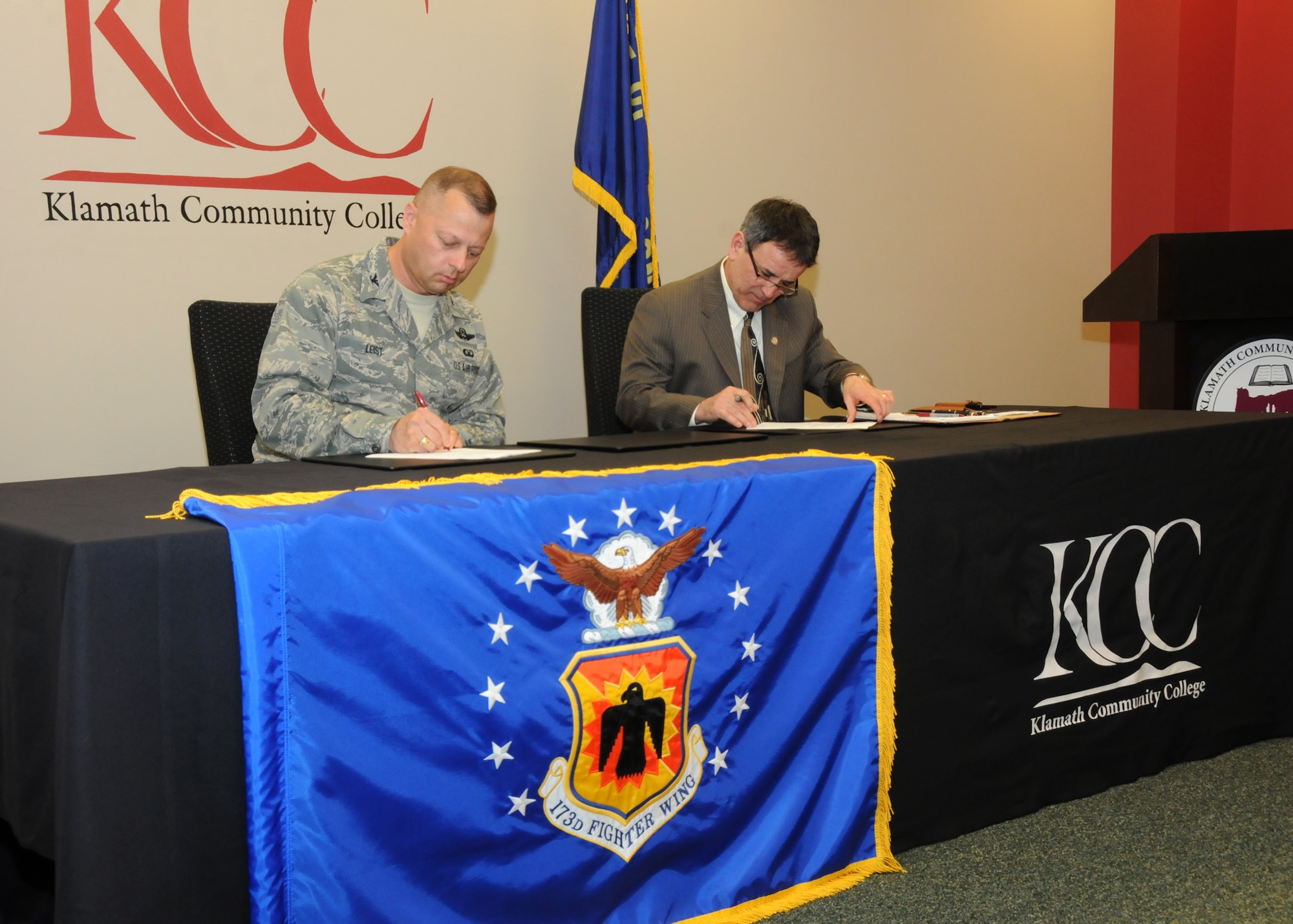 Oregon Air National Guard Col. Gregor Leist, 173rd Fighter Wing Vice Wing Commander, and Dr. Roberto Gutierrez, Klamath Community College President, sign a memorandum of understanding outlining their continuing partnership at KCC in Klamath Falls, Ore., April 16, 2014. The agreement between Kingsley Field and KCC will help members complete their Community College of the Air Force Degrees which will soon be mandatory for promotions. (U.S. Air National Guard photo by Senior Airman Penny Snoozy/Released)