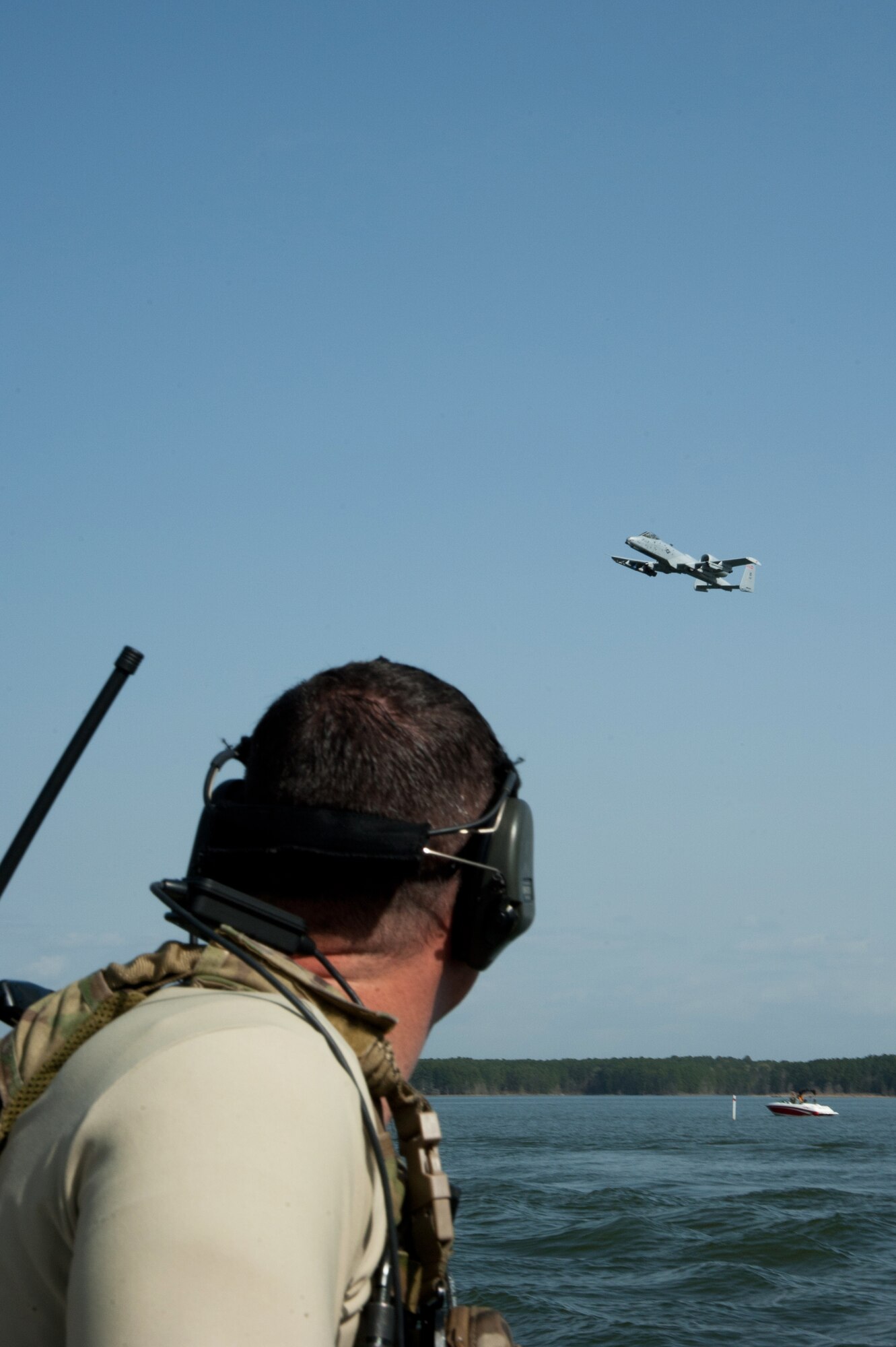 Maj. Nathan Glasscock, Air Liaison Officer, from the 122nd Air Support Operations Squadron, Louisiana Air National Guard, calls close air support (CAS) to the A-10 Thunderbolt II aircraft above. The 190th Fighter Squadron "Warthog" pilots trained with the CAS missions on the Toledo Bend Army recreational lake March 19 while deployed to Barksdale Air Force Base. (Air National Guard photo by Master Sgt. Becky Vanshur)



