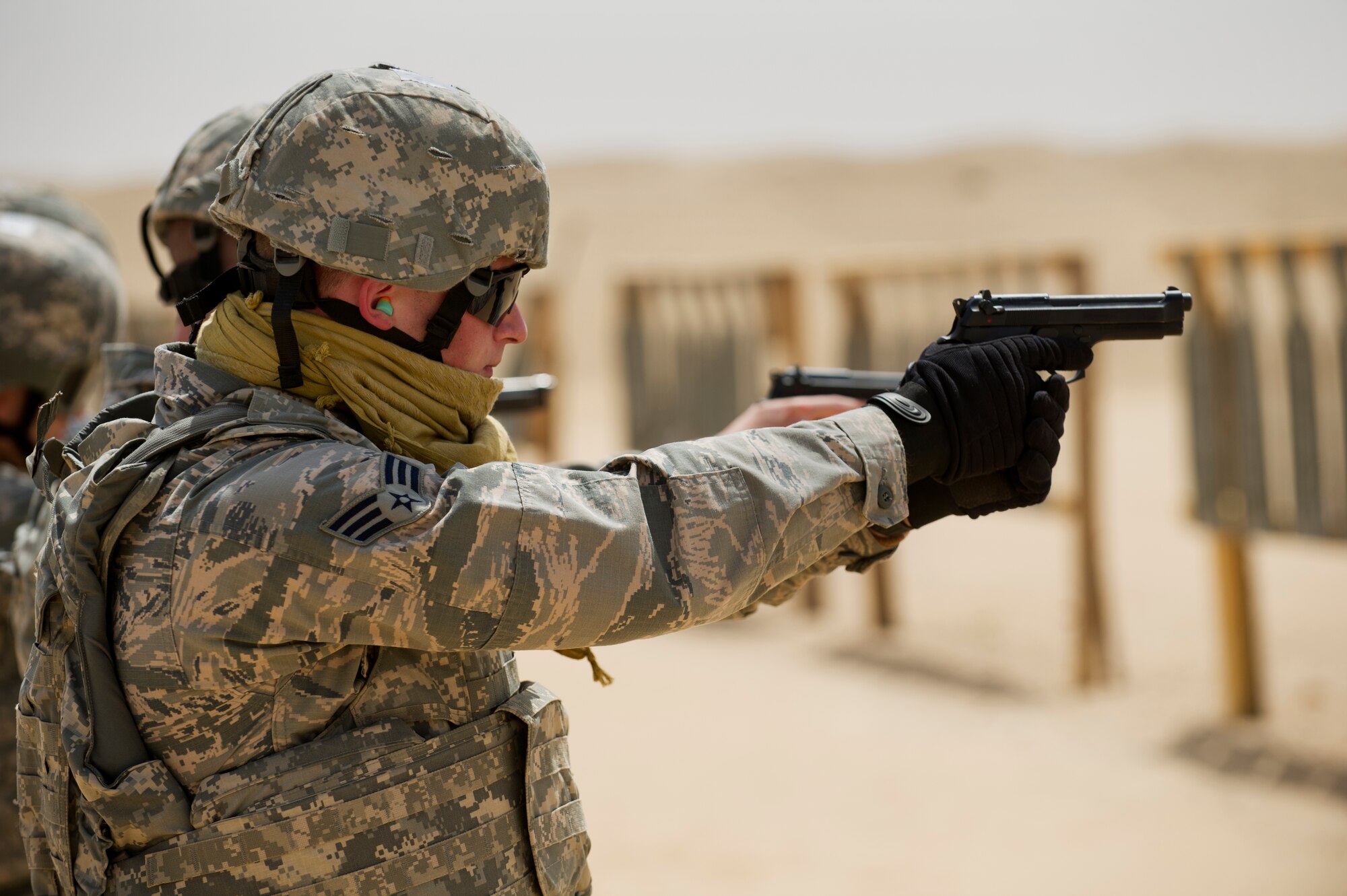 Senior Airman Jason Vanhoose, a Force Protection Airman with the 387th Expeditionary Support Squadron, engages targets with his M-9 pistol at a firing range at an undisclosed location in Southwest Asia.  Vanhoose, a native of Mt. Gilead, Ohio, is deployed from Kirtland Air Force Base, N.M.  Members of the 387th ESPTS Force Protection received weapons proficiency training with combat arms instructors from the 387th Expeditionary Security Forces Squadron while deployed to the AOR.  Because Force Protection Airmen act as augmentees to security forces, it is important that they receive on-going proficiency training to ensure they are ready to properly react and respond during times of increased threats.  (U.S. Air Force photo by Senior Master Sgt. Burke Baker)