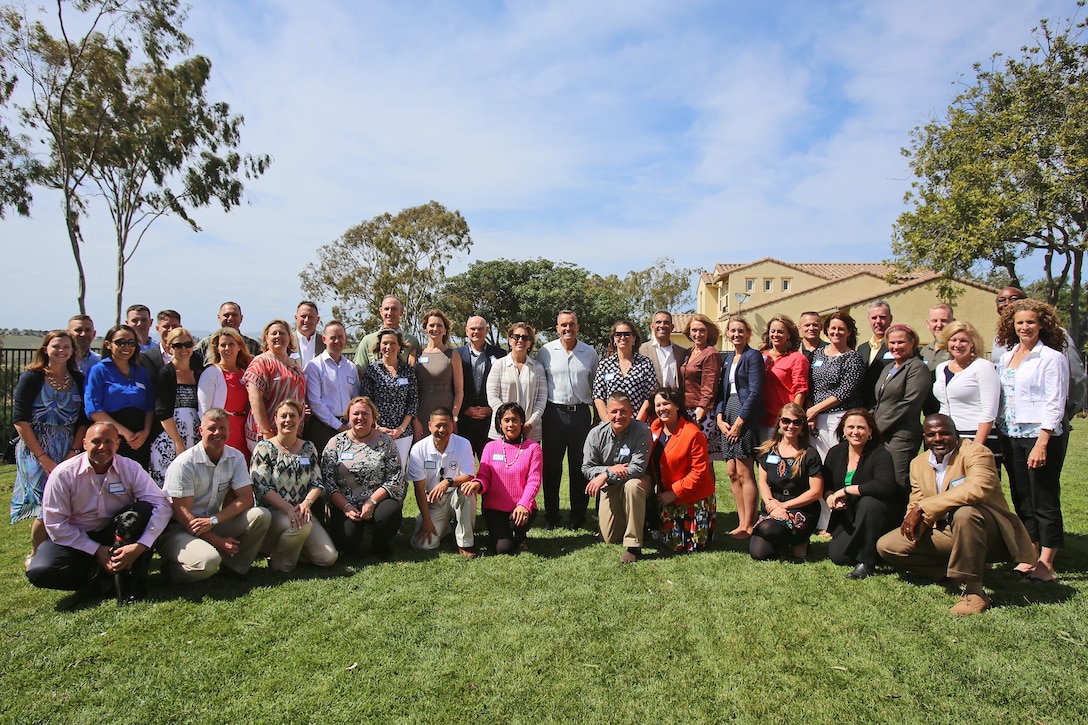 Senior leaders and family readiness officers gather together to honor Family Readiness Program volunteers with 1st Marine Logistics Group for their support in improving troop welfare and morale, aboard Camp Pendleton, Calif., April 27, 2014. Commanding officers from each unit with 1st MLG attended the gathering and met more than 45 volunteers from their respective units, showing their gratitude and honoring their efforts. The volunteers acknowledged at the event worked closely with the FROs before to host recreational activities on base, as well as provided care packages to deployed Marines, sailors and spouses with 7th Engineer Support Battalion, Combat Logistics Regiment 15, Combat Logistics Regiment 1, Headquarters Regiment, 1st Medical Battalion, 1st Dental Battalion and subordinate commands.