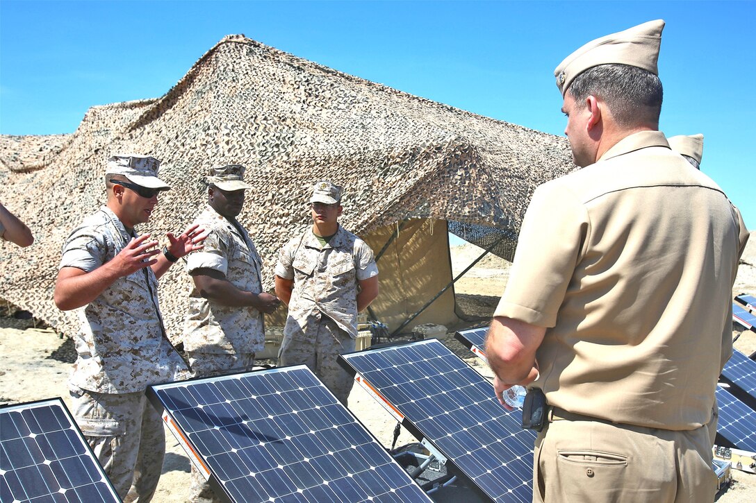 Marines with 7th Engineer Support Battalion, 1st Marine Logistics Group, highlight their unit’s capability to provide solar power in a humanitarian aid or disaster relief scenario to Navy officers during a Defense Support of Civil Authorities conference aboard Naval Base Coronado, Calif., April 29, 2014. The two-day event provided the opportunity for supporting agencies, partners and stakeholders to meet and discuss ideas that would reinforce relations and garner awareness of support goals and supporting agency abilities during local and national disasters. The blue-green team, including servicemembers from the Third Fleet, I Marine Expeditionary Force and 3rd Marine Aircraft Wing, educated attendees about existing and future capabilities to support disaster relief through conferences and displays of military tactical vehicle, aircraft and equipment.