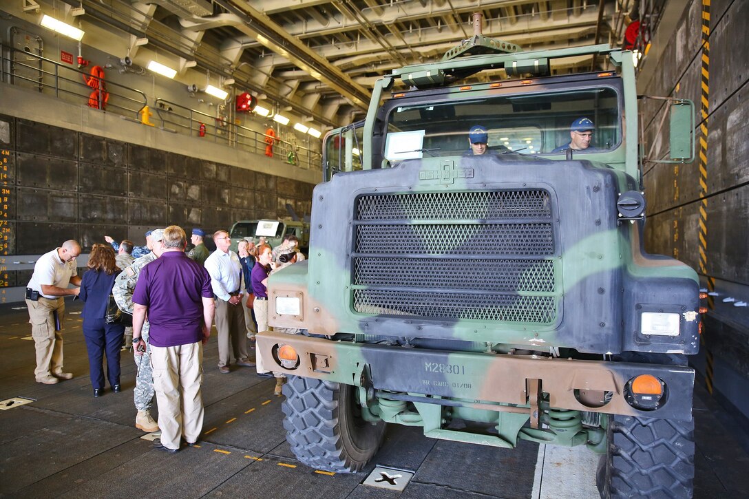 Servicemembers and officials with local, state and national agencies attend a static display of military vehicles during a Defense Support of Civil Authorities conference aboard Naval Base San Diego, Calif., April 29, 2014. The two-day event provided the opportunity for supporting agencies, partners and stakeholders to meet and discuss ideas that would reinforce relations and garner awareness of support goals and supporting agency abilities during local and national disasters. The blue-green team, including servicemembers from the Third Fleet, I Marine Expeditionary Force and 3rd Marine Aircraft Wing, educated attendees about existing and future capabilities to support disaster relief through conferences and displays of military tactical vehicle, aircraft and equipment.