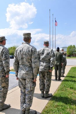 Members of the Delaware Air National Guard standby prior to a 166th Airlift Wing retreat ceremony May 3, 2014, at the New Castle ANG Base in New Castle, Del. Retreat serves a twofold purpose. It signals the end of the official duty day and serves as a ceremony for paying respect to the flag. (U.S. Air National Guard photo by Tech. Sgt. Robin Meredith)