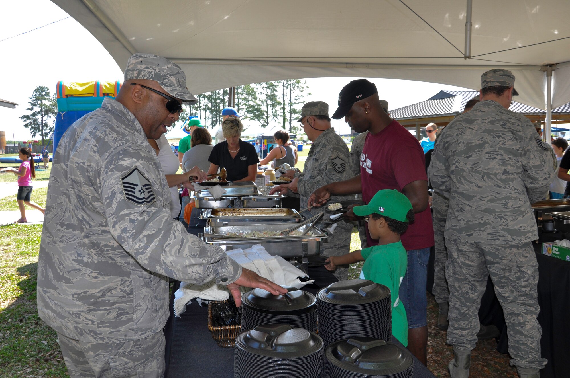 Servicemembers and their families from across the installation enjoy free food, live entertainment and activities during the annual Joint Base Charleston Appreciation Picnic May 3, 2014 at the Air Base picnic grounds. The two-day event, which was open to all of Team Charleston, had a wide-range of activities available to both adults and children, including a jousting station, inflatable water slide, corn hole tournament, and a mini C-17 static display. More than 2,000 people attended the picnic this year. (U.S. Air Force photo/Capt. Michaela Judge)