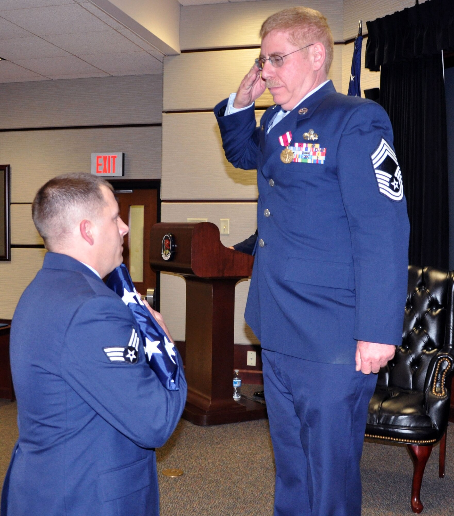 Chief Master Sgt. Dail Bruce, 931st Aircraft Maintenance Squadron, renders a salute to the U.S. flag during his retirement ceremony at McConnell Air Force Base, Kansas, May 4, 2014.  Bruce enlisted in the Air Force in 1981 and has served for 33 years.  He has spent the last 17 years of his career as a member of the 931st Air Refueling Group at McConnell.  (U.S. Air Force photo by Capt. Zach Anderson)