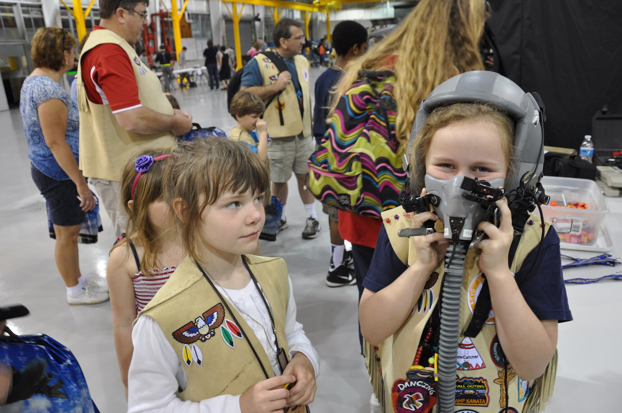 POPE FIELD, N.C. - Y Princess Madeleine Karl, daughter of Major Erin Karl, 440th Airlift Wing public affairs officer, tried on a pilot’s helmet while Y Princess Elizabeth Quesenberry looks on  at the 2014 Passport to Adventure held here, May 3.