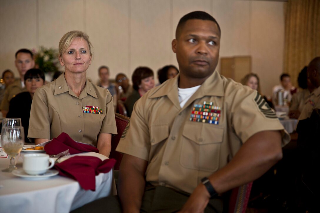 Col. Katherine J. Estes, left, and Master Gunnery Sgt. Gary M. Moore Jr. listen as anonymous statements from sexual assault victims are read during a Sexual Assault Prevention and Response luncheon April 25 at the Butler Officers’ Club on Camp Foster. “It was really great to see people from the highest levels of command and even down to junior Marines representing their support for the program,” said Lance Cpl. Brittany D. Tobin, a Grand Junction, Colo., native. “I really think this program is doing a great thing and that I hope to see more improvements within units and all the branches on this issue.” Tobin is a motor transport operator with Marine Wing Support Squadron 172, Marine Aircraft Group 36, 1st Marine Aircraft Wing, III Marine Expeditionary Force. Estes is the commanding officer of Headquarters and Service Battalion, Marine Corps Base Camp Smedley D. Butler, Marine Corps Installations Pacific, and camp commander for Camps Foster and Lester. Moore, a Washington D.C. native is the postal chief of H&S Bn., MCB Camp Butler.