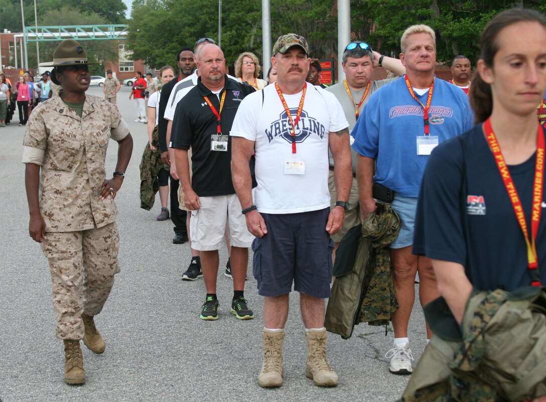 MARINE CORPS RECRUIT DEPOT PARRIS ISLAND, S.C. – (Left) Staff Sgt. Cheryle Milton, a drill instructor, explains to educators how to create a formation during the Educators Workshop here, April 30, 2014. The three-day workshop gave educators a chance to experience the day to day routines aboard the depot and Marine Corps Air Station Beaufort. The purpose of the workshop is to give educators a better understanding of the Marine Corps and reinforce the idea of the Marine Corps as a viable career option. (U.S. Marine Corps photo by Lance Cpl. Stanley Cao)