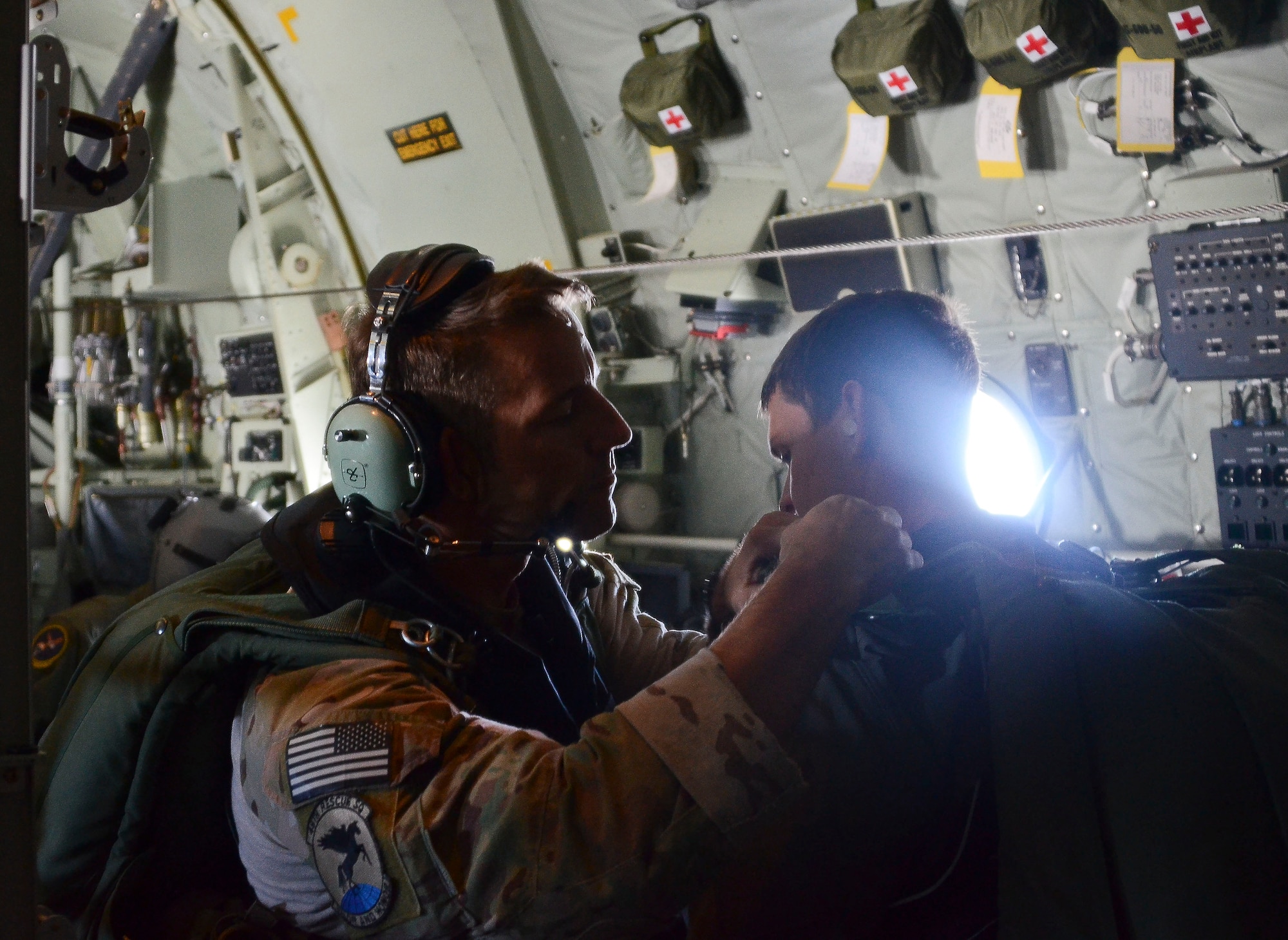 Pararescue Airmen from the 48th Rescue Squadron perform a function check on their gear before parachuting into the Pacific Ocean May 3, 2014, to aid two critically-injured sailors aboard a Venezuelan fishing boat. The Airmen flew in two HC-130J Combat King II aircraft and three HH-60 Pavehawk helicopters for nearly 11 hours, and then parachuted into the ocean 1,100 nautical miles from the Mexican coast with two inflatable zodiac boats and medical equipment to deliver lifesaving care. (U.S. Air Force photo/Staff Sgt. Adam Grant) 