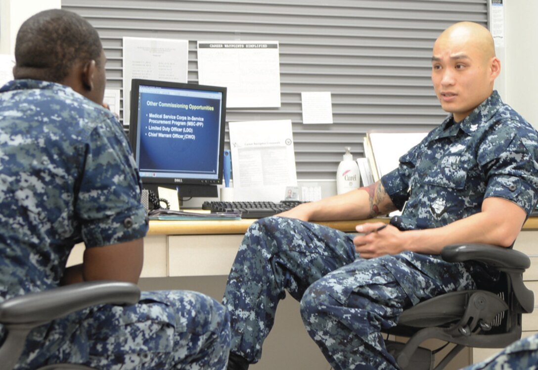 Jacksonville Semper Fidelis Society Gung Ho Award recipient Petty Officer 2nd Class Bryan Nguyen career counselor, Naval Branch Clinic Albany (right), advises Seaman Donovan Scales, general duty corpsman, NBHC Albany, of career and educational opportunities, Tuesday.