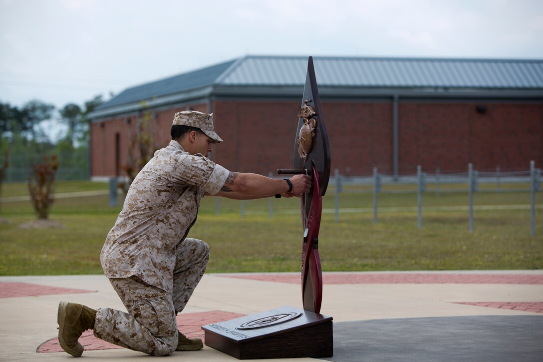 A Critical Skill Operator, with U.S. Marine Corps Forces Special Operations Command, takes a knee and gently hangs the dog tags of one of his fallen comrades on the MARSOC Honor the Fallen memorial, during ‘Honor the Fallen,’ a one-of-a-kind event, April 25, at the MARSOC headquarters, to honor all Marines, sailors and civilian Marines lost at home and abroad since MARSOC’s inception. “Honor the Fallen is about honoring and reflecting upon the memory and life of all of our fallen MARSOC Marines and sailors to include all civilians who have served with MARSOC in any capacity, and the remarkable contributions they made in serving our great nation, protecting our freedom and liberties,” said Kristin Smith, the Family Readiness Officer for MARSOC headquarters.  “We are remembering and honoring all of our fallen with the respect they so much deserve.”