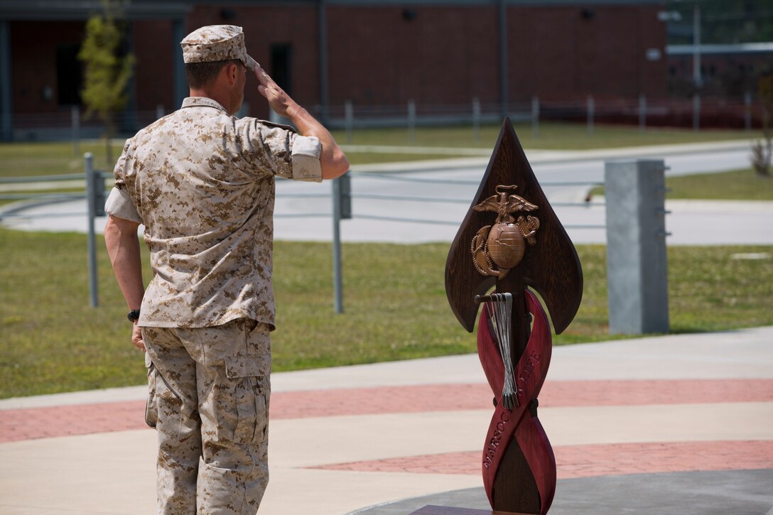 A Critical Skill Operator, with U.S. Marine Corps Forces Special Operations Command, renders a salute, after gently hanging the dog tags of one of his fallen comrades on the MARSOC Honor the Fallen memorial, during ‘Honor the Fallen,’ a one-of-a-kind event, April 25, at the MARSOC headquarters, to honor all Marines, sailors and civilian Marines lost at home and abroad since MARSOC’s inception. “Honor the Fallen is about honoring and reflecting upon the memory and life of all of our fallen MARSOC Marines and sailors to include all civilians who have served with MARSOC in any capacity, and the remarkable contributions they made in serving our great nation, protecting our freedom and liberties,” said Kristin Smith, the Family Readiness Officer for MARSOC headquarters.  “We are remembering and honoring all of our fallen with the respect they so much deserve.”