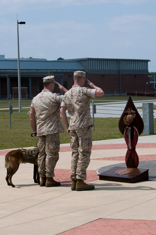 A Critical Skill Operator, and a Multipurpose Canine Handler, both with U.S. Marine Corps Forces Special Operations Command, render a salute, after gently hanging the dog tags of one of their fallen comrades on the MARSOC Honor the Fallen memorial, during ‘Honor the Fallen,’ a one-of-a-kind event, April 25, at the MARSOC headquarters, to honor all Marines, sailors and civilian Marines lost at home and abroad since MARSOC’s inception. “Honor the Fallen is about honoring and reflecting upon the memory and life of all of our fallen MARSOC Marines and sailors to include all civilians who have served with MARSOC in any capacity, and the remarkable contributions they made in serving our great nation, protecting our freedom and liberties,” said Kristin Smith, the Family Readiness Officer for MARSOC headquarters.  “We are remembering and honoring all of our fallen with the respect they so much deserve.”