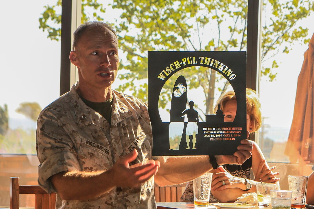 Lieutenant Col. William Wischmeyer, executive officer, 15th Marine Expeditionary Unit, holds up a farewell gift and  thanks Marines, sailors and family members for their support during his career after his retirement ceremony aboard Camp Pendleton, Calif., May 1, 2014. Wischmeyer, 48, is from Clay, S.D. (U.S. Marine Corps photo by Sgt. Jamean Berry/Released)