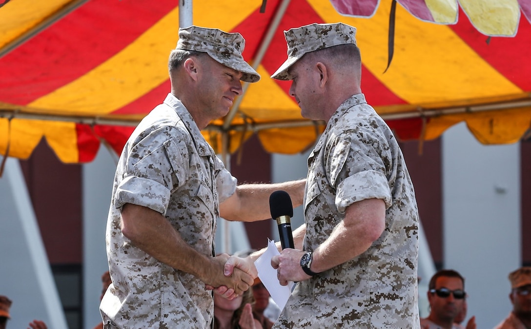 Lieutenant Col. John R. O'Neal, commanding officer, 15th Marine Expeditionary Unit, right, thanks and congratulates Lt. Col. William D. Wischmeyer, executive officer, 15th MEU, for his dedication to the Marine Corps during his retirement ceremony aboard Camp Pendleton, Calif., May 1, 2014. Wischmeyer, 48, is from Clay, S.D. (U.S. Marine Corps photo by Cpl. Emmanuel Ramos/Released)