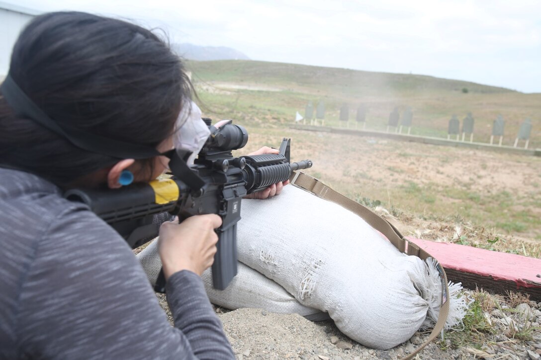 A participant of the Spartan Spouse Day held by the 9th Communication Battalion fires an M4 assault rifle at targets during a practice shoot aboard Camp Pendleton, Calif., April 25. Marine spouses were invited to see what their significant others have gone through in training and their typical workdays.