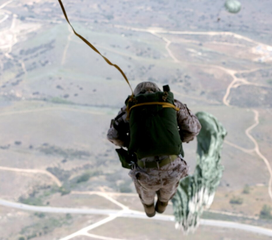 Marines participating in 1st Radio Reconnaissance Platoon’s static-line exercise jump from a Lockheed C-Hercules transportation aircraft over the landing zone aboard Marine Corps Base Camp Pendleton, Calif., April 23, 2014. The jump involved Marines from different units on Camp Pendleton tested their abilities while in the air.