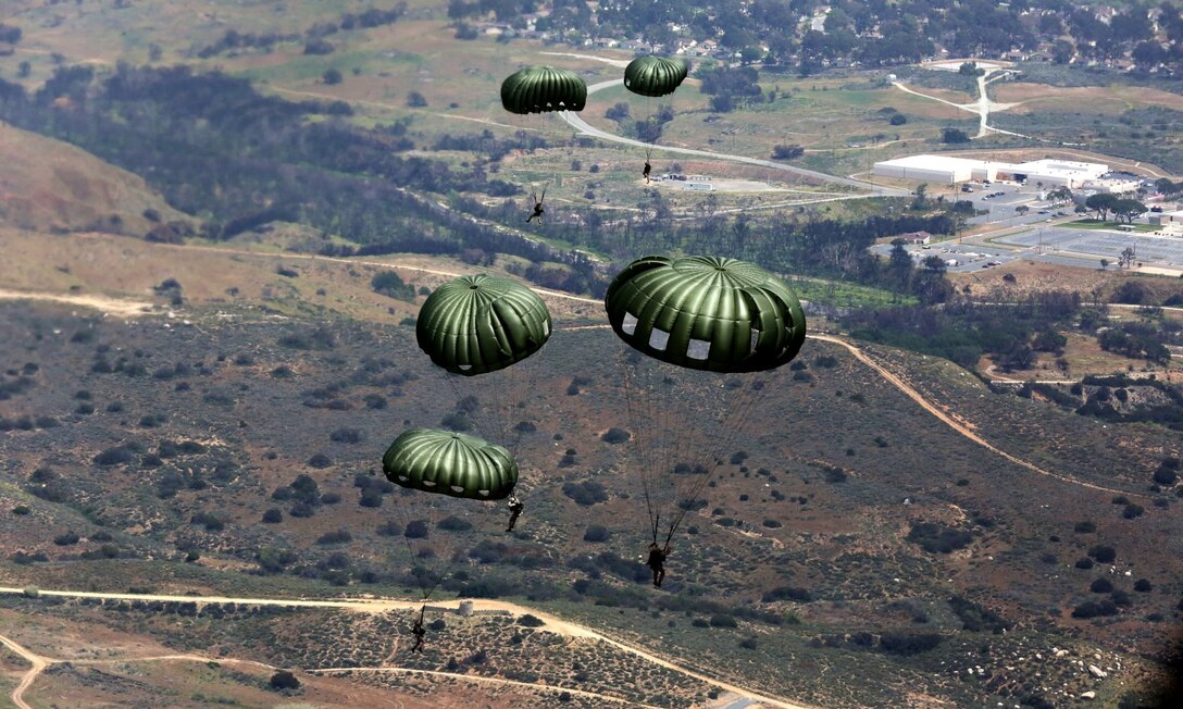 Marines participating in 1st Radio Reconnaissance Platoon’s static-line exercise parachute on to the landing zone aboard Marine Corps Base Camp Pendleton, Calif., April 23, 2014. The jump was conducted to ensure airborne qualified Marines are up to speed in the proper parachuting techniques and procedures.
