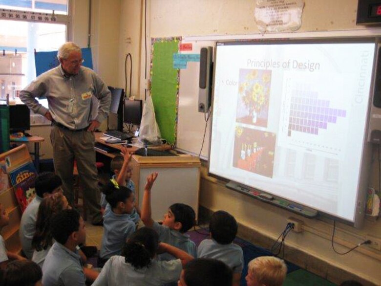 Jose Mendez, project manager in the Antilles Office, talks with Antilles Elementary School students about the principles of design, in preparation for their project to design a playground.