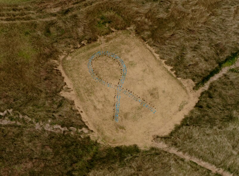 Members from the 33rd Rescue Squadron flyover the Sexual Assault Prevention and Response ribbon on Kadena Air Base, during a training exercise April 15, 2014. The ribbon was placed by Kadena's SAPR program to raise awareness and express the support that is here for survivors. (U.S. Air Force photo by Airman 1st Class Keith James)