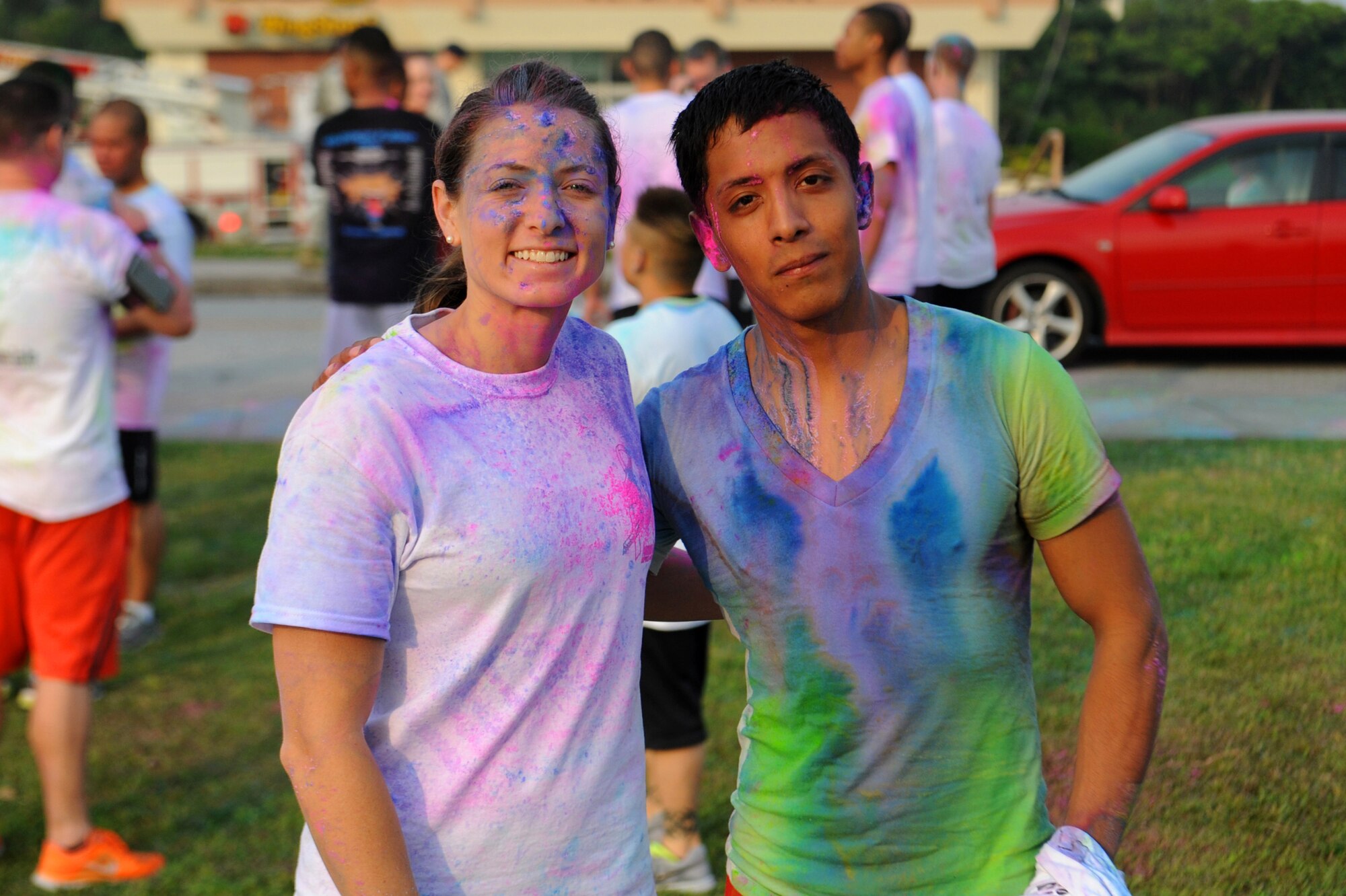 U.S. Air Force Capt. Sara Beth Hershey, 18th Aeromedical Evacuation Squadron flight nurse, and Senior Airman Francisco Andraca, 18th Component Maintenance Squadron aerospace propulsion technician, stand together after completing a color run on Kadena Air Base, Japan, April 30, 2014. Hershey and Andraca were the female and male first place runners during the event, which was held to bring awareness to sexual assault, alcohol and child abuse.  (U.S. Air Force photo by Airman 1st Class Zackary A. Henry)
