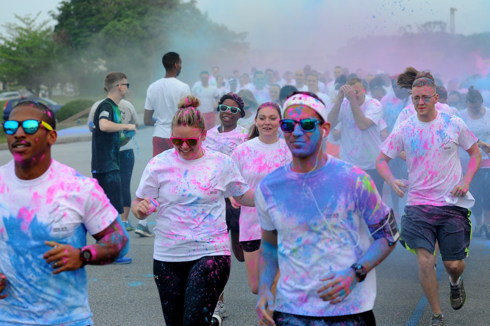 Members from Team Kadena run during the Sexual Assault Prevention and Response color run on Kadena Air Base, Japan, April 30, 2014. Before the run, a children's raffle was held and the winner, Sophia Angulo, donated her $10 prize to SAPR.  (U.S. Air Force photo by Airman 1st Class Zackary A. Henry)