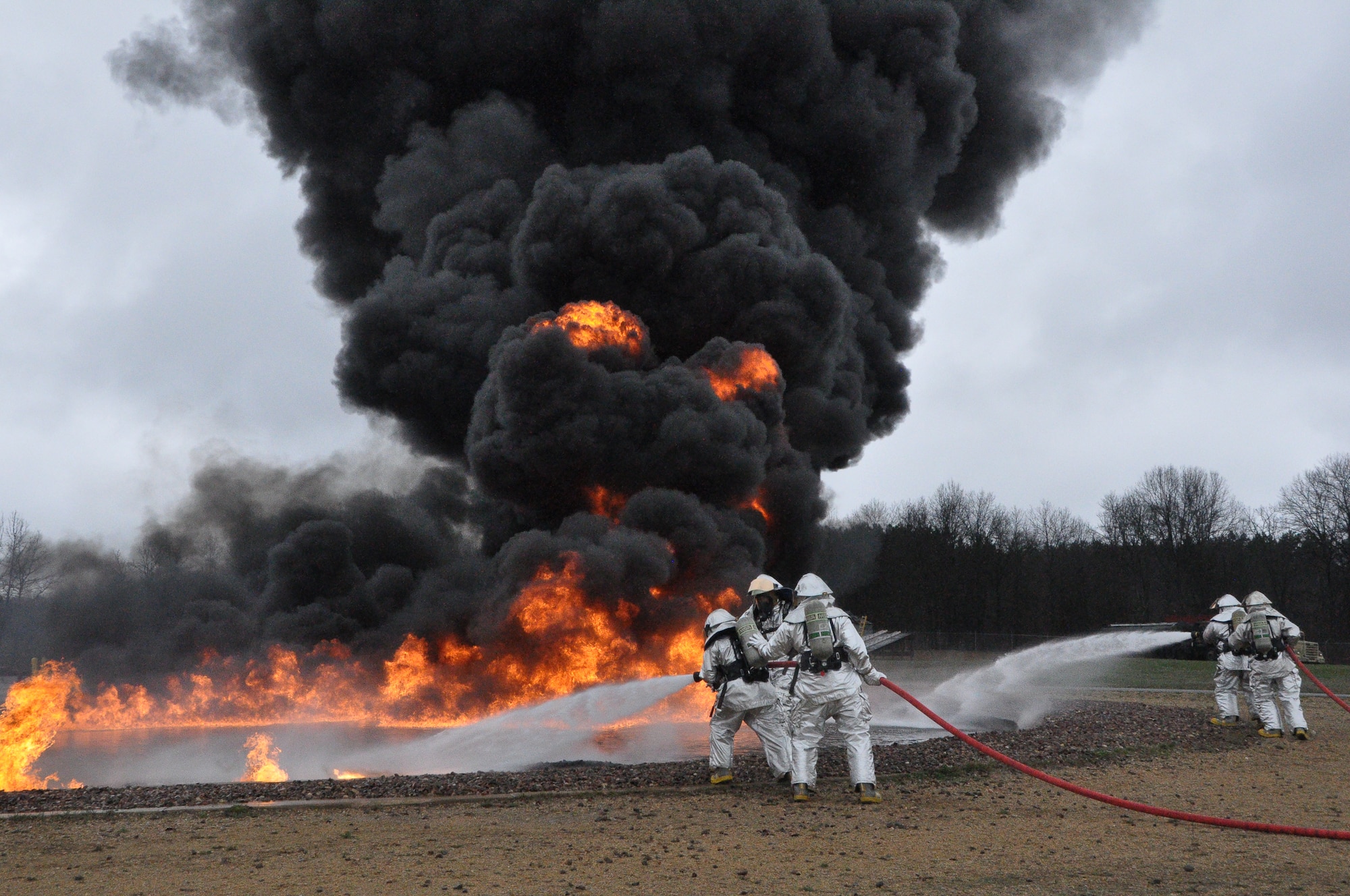 Firefighters with the 433rd Civil Engineer Squadron train in pit burning at Fort McCoy, Wisconsin April 30 in support of Exercise Patriot Warrior. These Reservists have a dual role of training in bare base operations while responsible for real world emergencies. (U.S. Air Force photo by 1st Lt. Denise Haeussler)