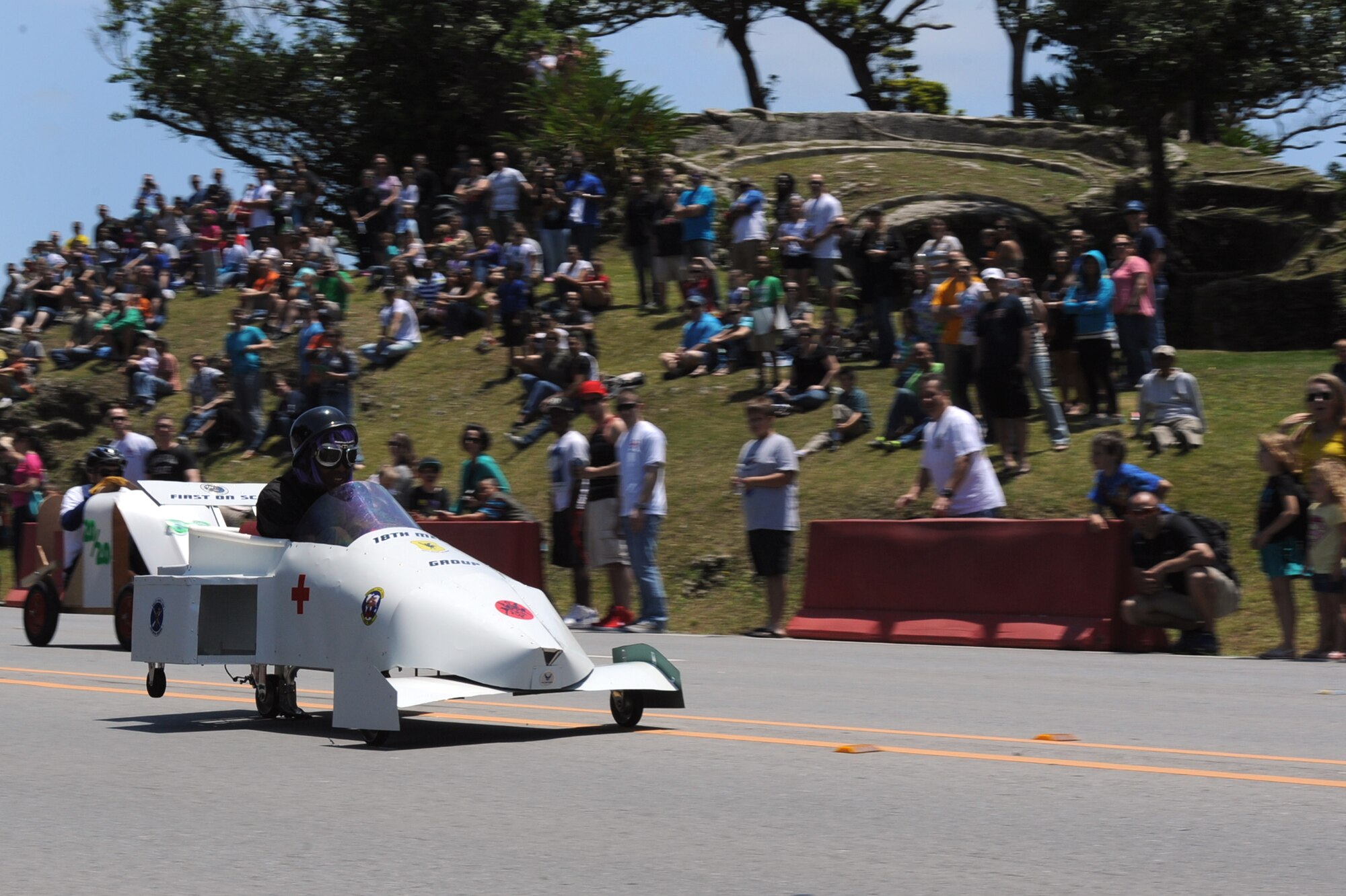 U.S. Air Force Tech. Sgt. Jennifer Randolph, 18th Medical Group NCO in charge of the health and wellness center, pulls ahead of her competitor in the “Shogun Medic” car during the Red Cross Derby Day competition on Kadena Air Base, Japan, April 26, 2014.  Approximately 25 active duty and civilian teams entered the competition, which raised more than $5,000 for Red Cross disaster relief services. (U.S. Air Force photo by Airman 1st Class Zade C. Vadnais)
