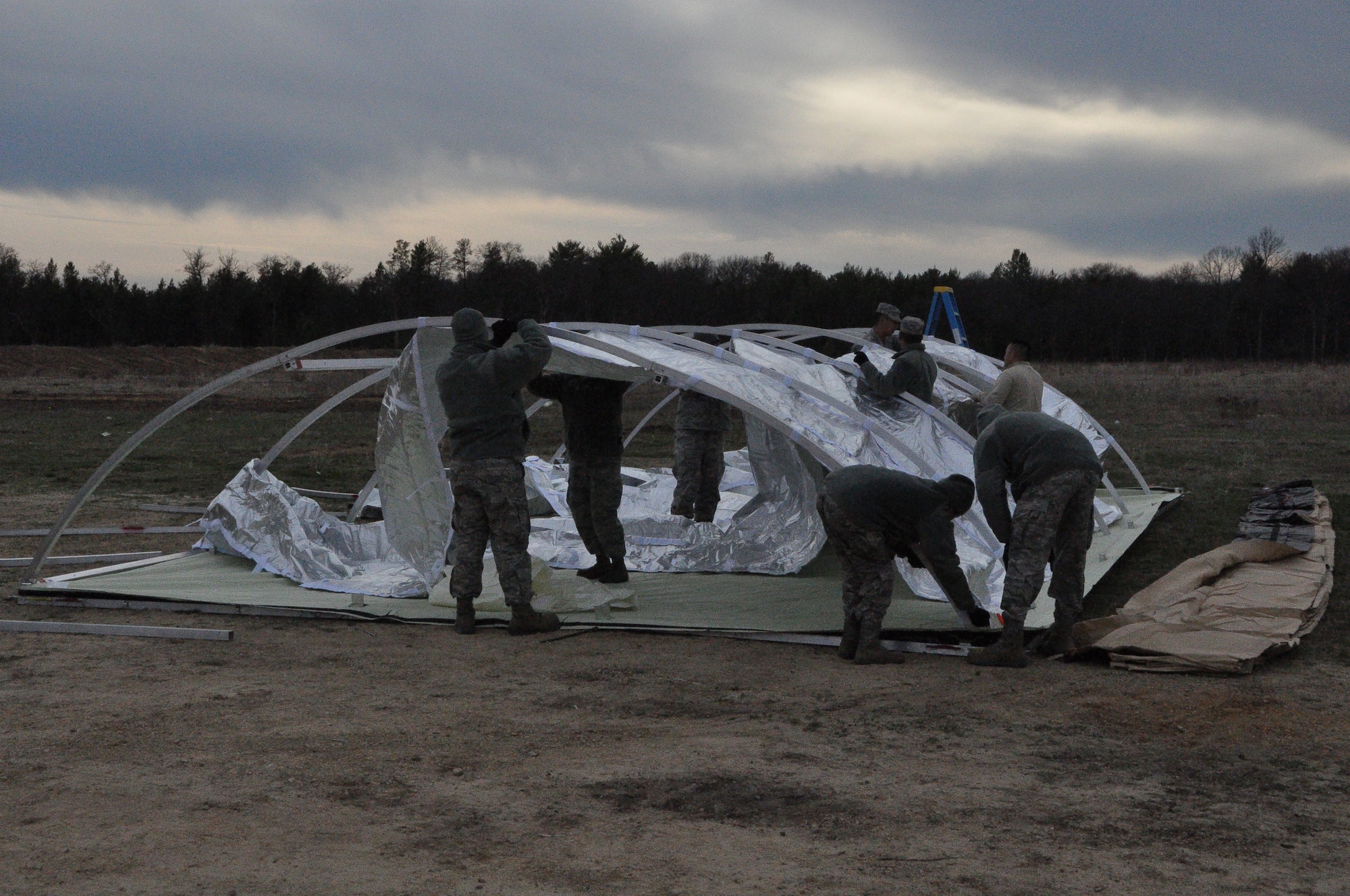 Bed down begins as the 433rd Civil Engineer Squadron constructs tents for living and working April 26 in support of Exercise Patriot Warrior 2014. The Air Force Reserve supports the Army with base bed down and sustainment as medical personnel train to move injured personnel out of a war zone to a higher echelon of care. (U.S. Air Force photo by 1st Lt. Denise Haeussler)