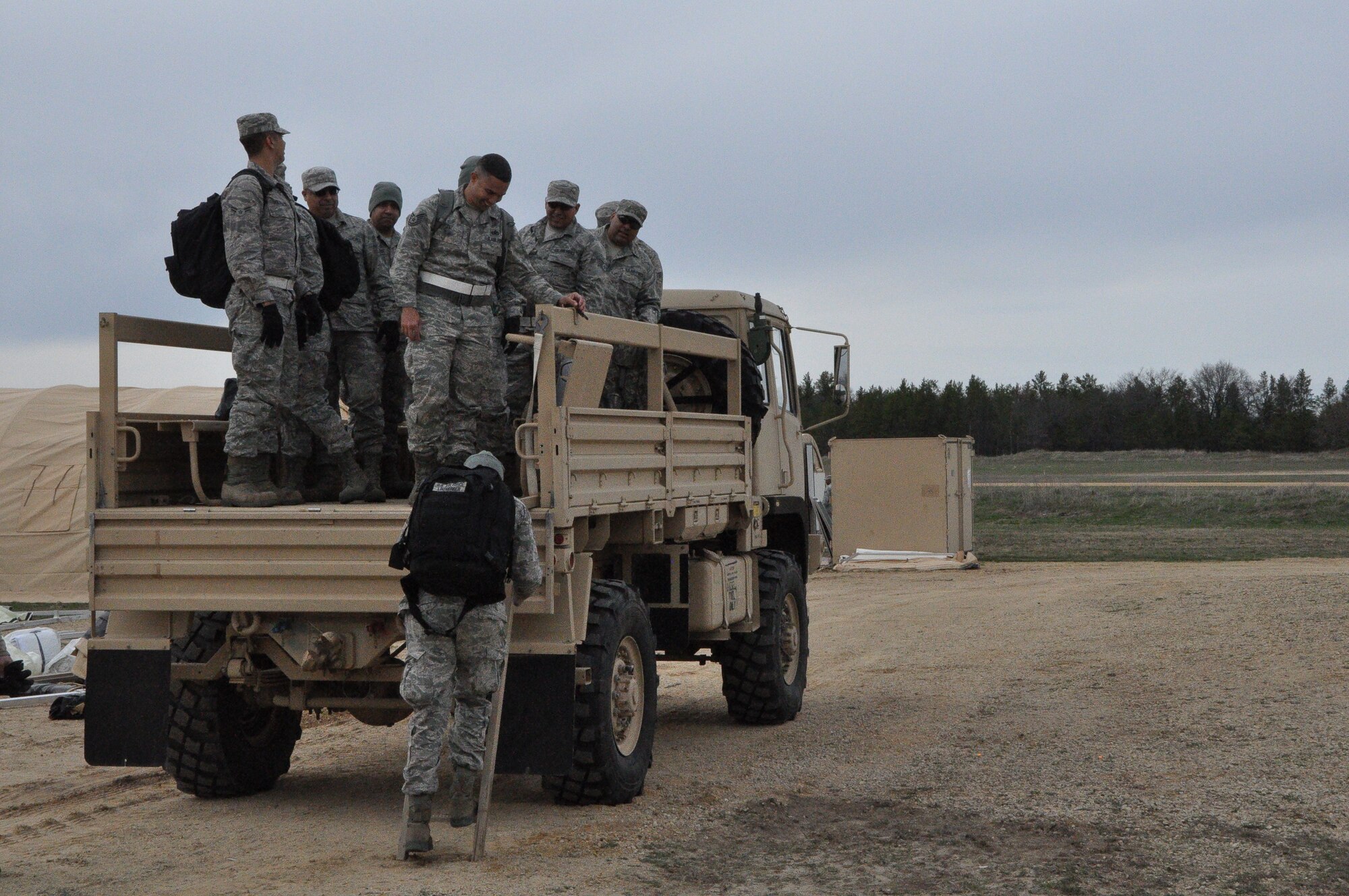 The Alamo Wing Civil Engineer Squadron arrives at the Forward Operating Base in freezing Fort McCoy, Wis., to support Exercise Patriot Warrior April 26. These Air Force Reservists from the 433rd Airlift Wing are responsible for base bed down in an austere environment for the first 72 hours; then their responsibility is base sustainment once the exercise kicks off. (U.S. Air Force photo by 1st Lt. Denise Haeussler)