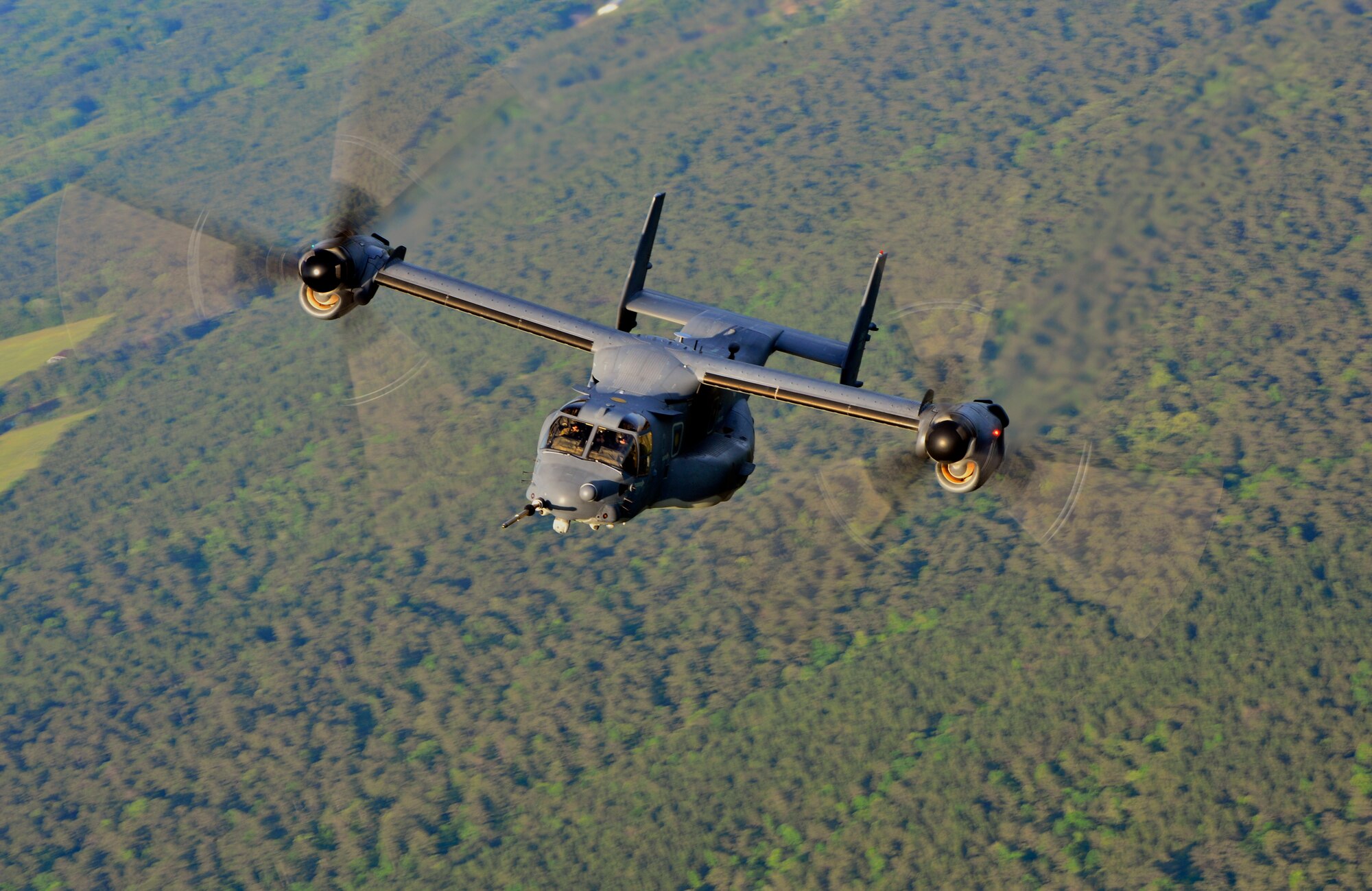 A U.S. Air Force CV-22 Osprey from the 8th Special Operations Squadron, fly over an disclosed location before dropping members of the Deployed Aircraft Ground Response Element (DAGRE) during Emerald Warrior, May 2, 2014. Emerald Warrior is an annual, joint exercise to train special operations, conventional and partner nation forces in combat scenarios to hone special operations air and ground combat skills, and is the Department of Defense's only irregular warfare exercise. (U.S. Air Force photo by Airman 1st Class Jasmonet Jackson)