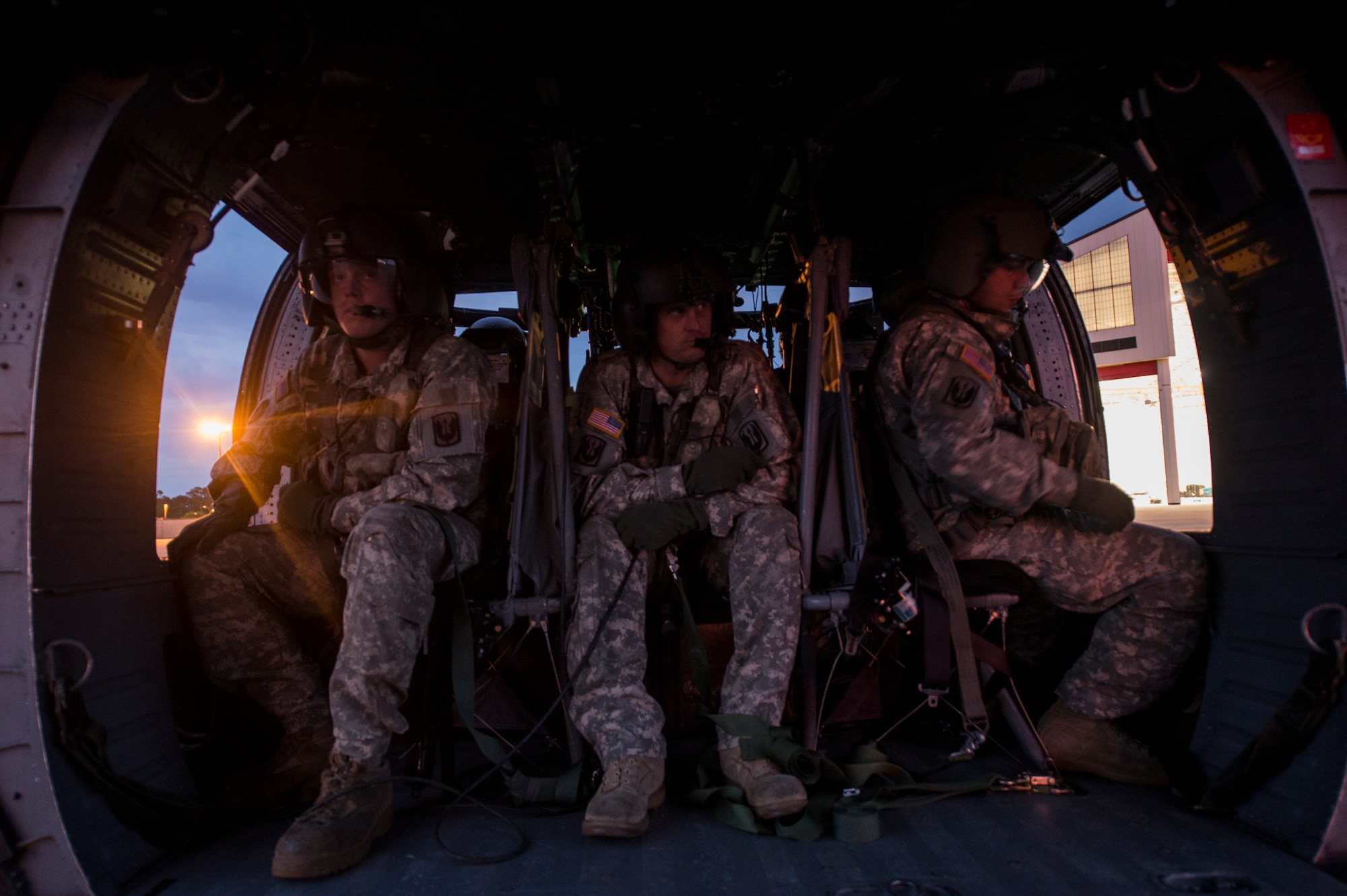 U.S. Army crew members of a UH-60 Black Hawk sit aboard the black hawk to conduct fast rope training with the U.S. Army 20th Special Forces Squadron, during Emerald Warrior 2014, Gulfport, Miss., April 30, 2014. Emerald Warrior is an annual, joint exercise to train special operations, conventional and partner nation forces in combat scenarios designed to hone special operations air and ground combat skills, and is the Department of Defense's only irregular warfare exercise.  (U.S. Air Force photo by Senior Airman Jodi Martinez)
