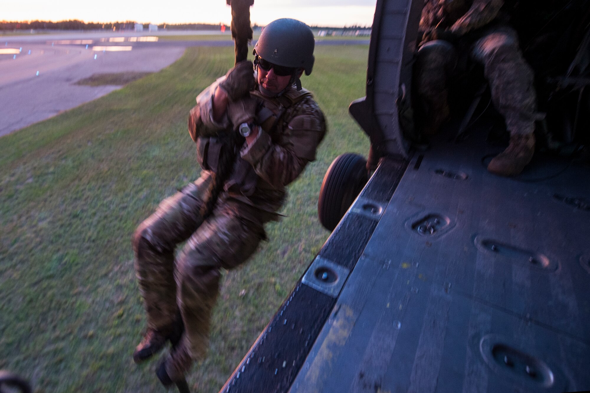 A member of the U.S. Army 20th Special Forces Squadron fast ropes from a UH-60 Black Hawk during Emerald Warrior 2014, Gulfport, Miss., April 30, 2014. Emerald Warrior is an annual, joint exercise to train special operations, conventional and partner nation forces in combat scenarios designed to hone special operations air and ground combat skills, and is the Department of Defense's only irregular warfare exercise.  (U.S. Air Force photo by Senior Airman Jodi Martinez)