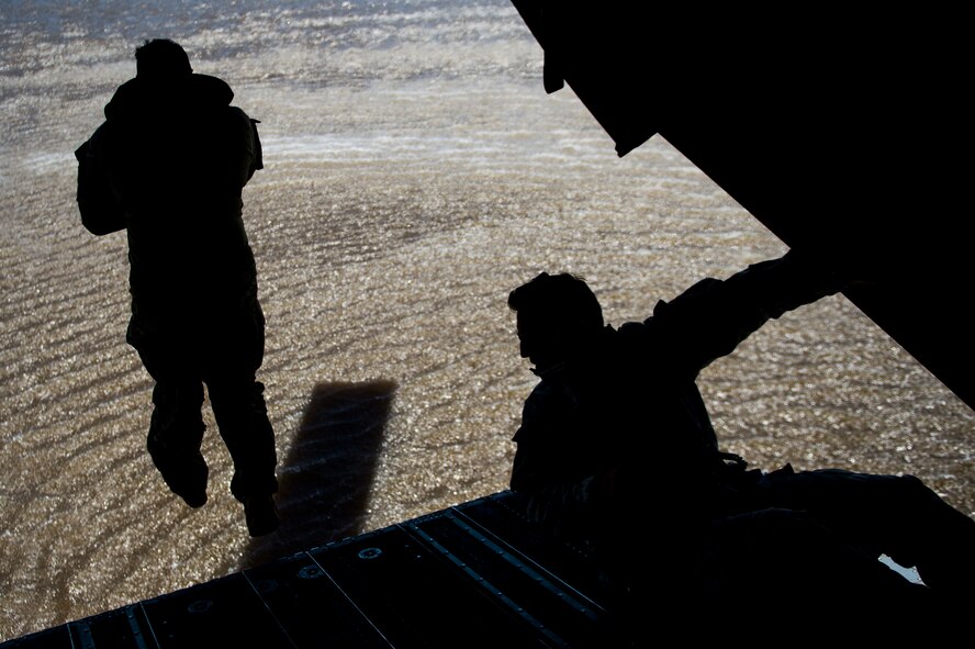 A member of the U.S. Army 20th Special Forces Squadron jumps from a CH-47 Chinook for helocast training, an airborne technique used by small forces to insert into a military area of operations, during Emerald Warrior 2014, Gulfport, Miss., April 30, 2014. Emerald Warrior is an annual, joint exercise to train special operations, conventional and partner nation forces in combat scenarios designed to hone special operations air and ground combat skills, and is the Department of Defense's only irregular warfare exercise.  (U.S. Air Force photo by Senior Airman Jodi Martinez)
