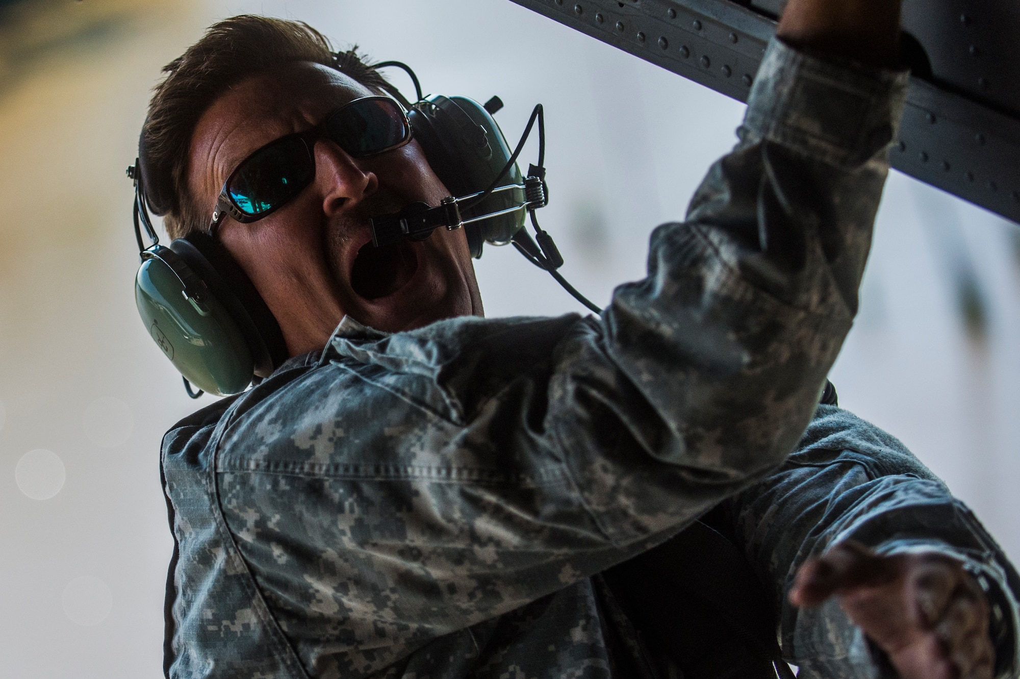 U.S. Army Chief Warrant Officer Tim Sewseyey yells out commands for a CH-47 Chinook helocast training, an airborne technique used by small forces to insert into a military area of operations, during Emerald Warrior 2014, Gulfport, Miss., April 30, 2014. Emerald Warrior is an annual, joint exercise to train special operations, conventional and partner nation forces in combat scenarios designed to hone special operations air and ground combat skills, and is the Department of Defense's only irregular warfare exercise.  (U.S. Air Force photo by Senior Airman Jodi Martinez)

