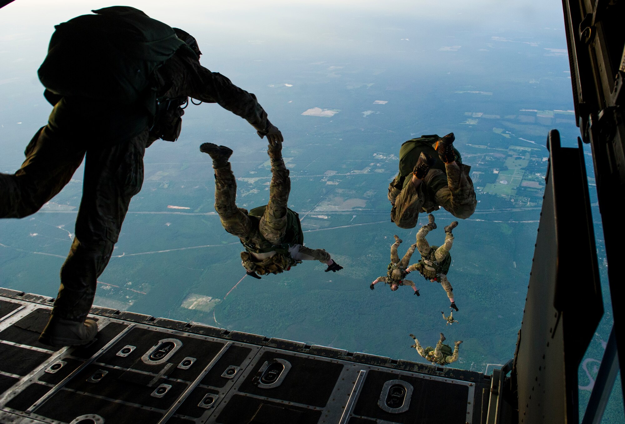 Members with the 22nd Special Tactics Squadron jump from an MC-130H Combat Talon II during Emerald Warrior over Hurlburt Field, Fla., May 2, 2014. Emerald Warrior is an annual, joint exercise to train special operations, conventional and partner nation forces in combat scenarios designed to hone special operations air and ground combat skills, and is the Department of Defense's only irregular warfare exercise. (U.S. Air Force photo by Staff Sgt. Marleah Miller)