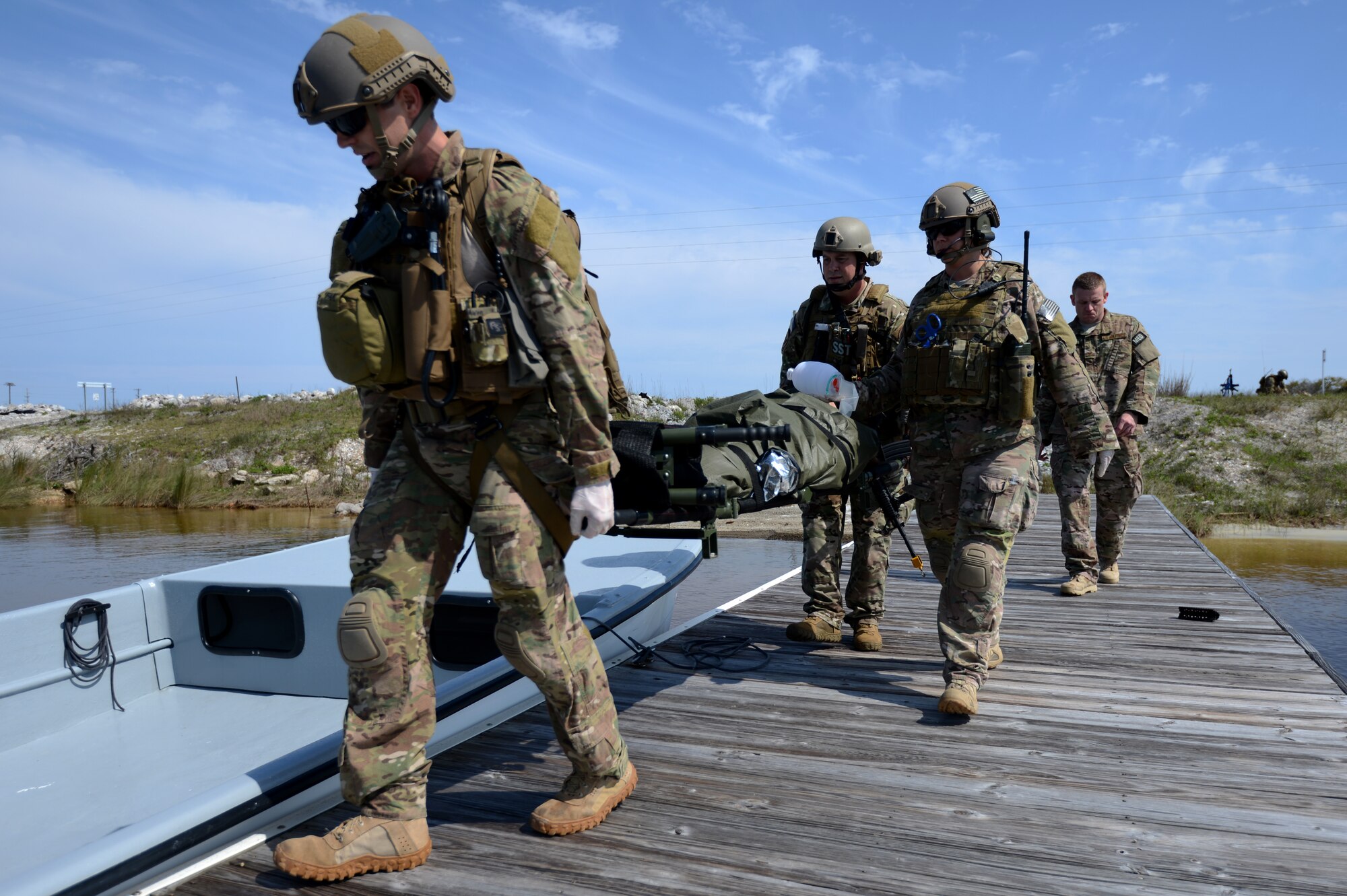 U.S. Air Force Airmen from the 919th Special Operations Security Forces Squadron, Duke Field, and the 1st Special Operations Support Squadron, Hurlburt Field Air Force Base, participate in a mock deployment situation which injured Airmen are found, given medical care, and extracted as a part of Emerald Warrior, Hurtlburt Field Air Force Base, Fla., May 02, 2014. Emerald Warrior is an annual, joint exercise to train special operations, conventional and partner nation forces in combat scenarios designed to hone special operations air and ground combat skills, and is the Department of Defense's only irregular warfare exercise. (U.S. Air Force photo by Senior Airman Justyn M. Freeman)